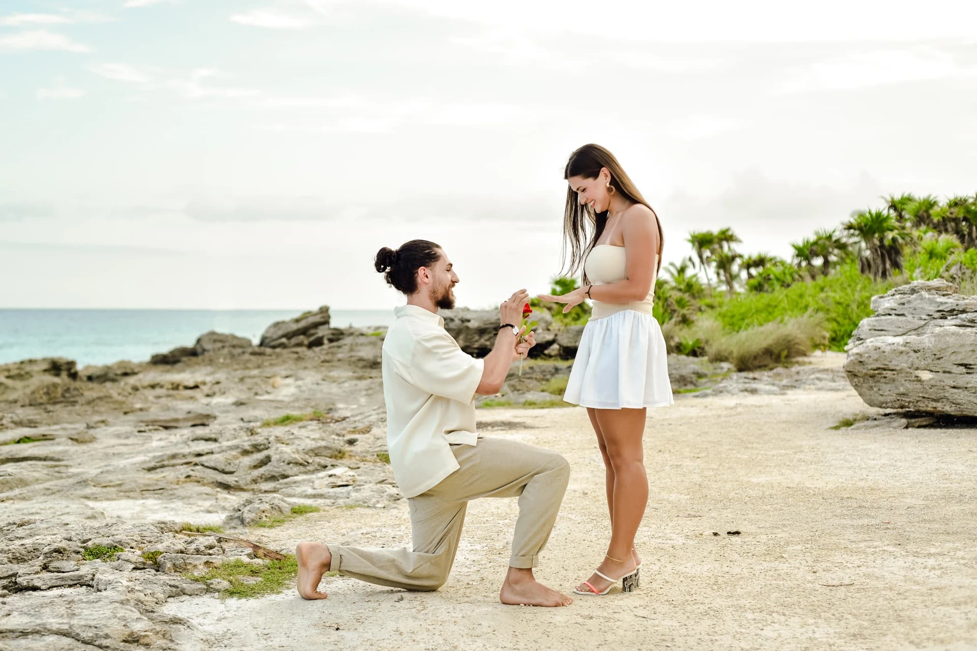 Couple embracing seconds after a beach proposal in the Riviera Maya