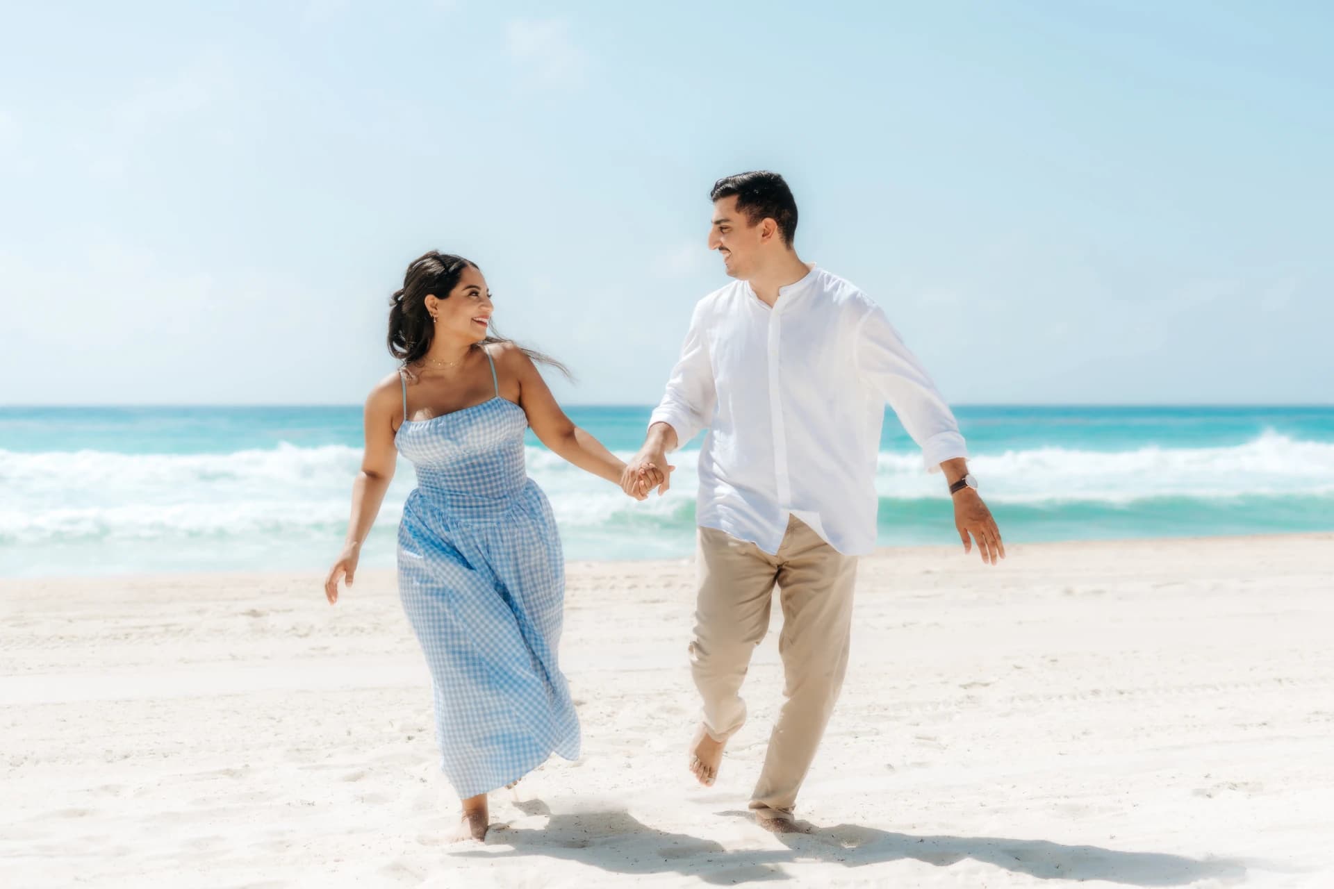 Couple walking hand in hand on the beach, Playa del Carmen
