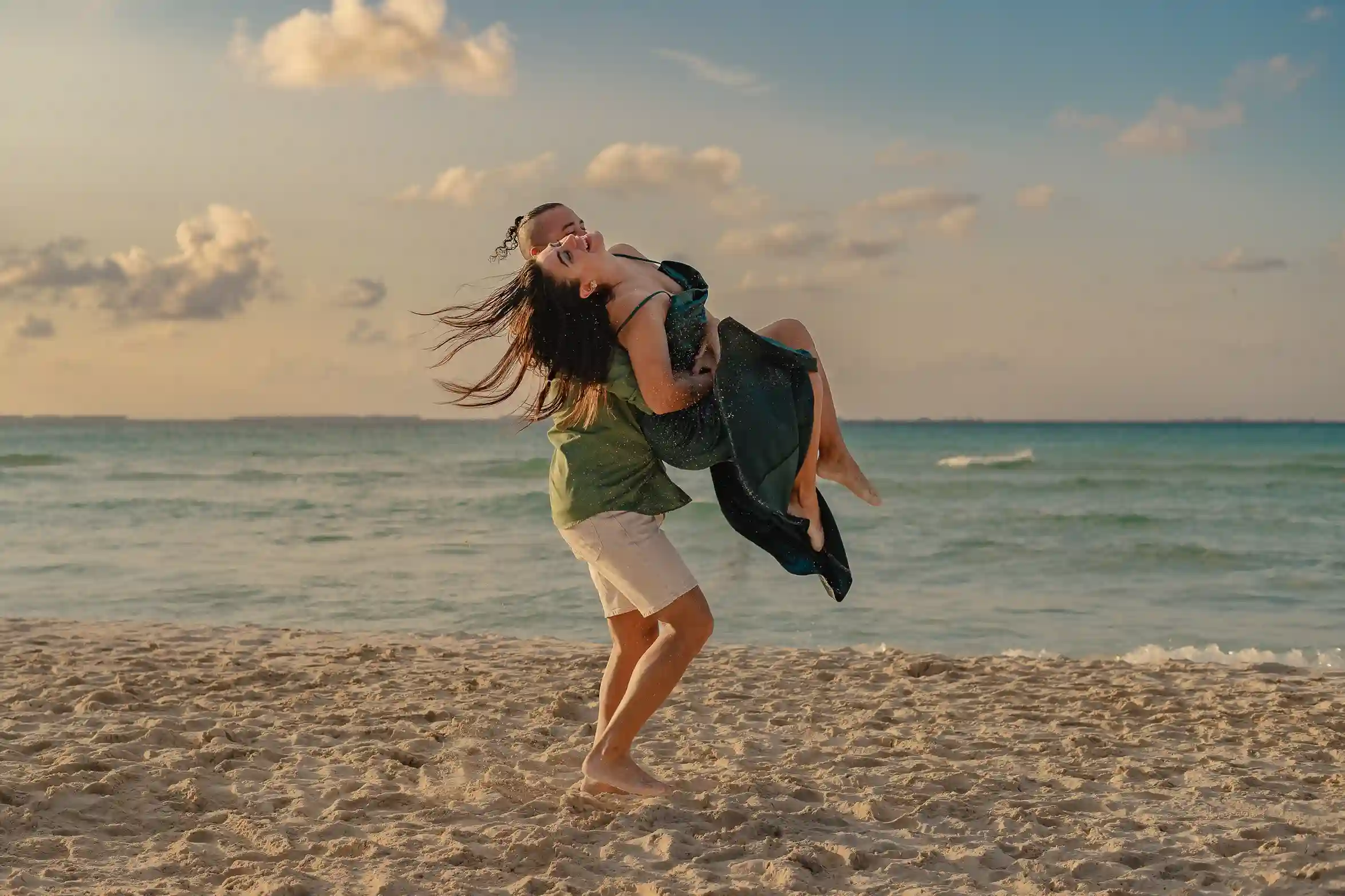 Couple walking together on a Caribbean beach at sunset