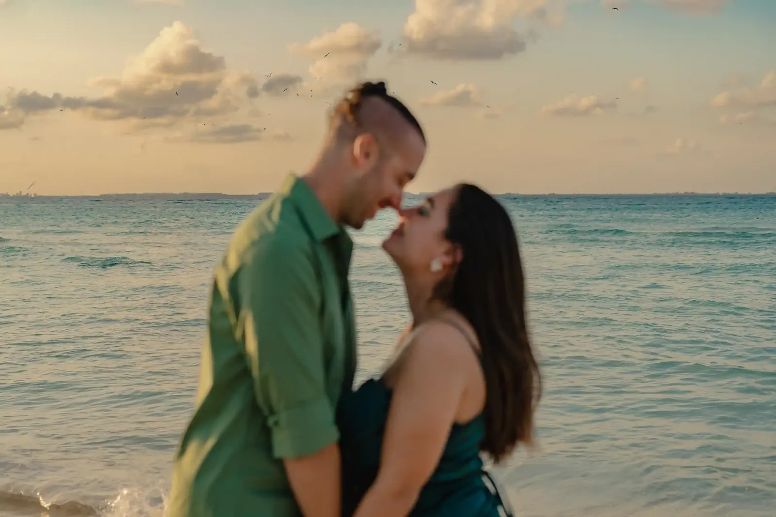 Couple on a Cancún beach in the last light before sunset — the best time of day for beach photos