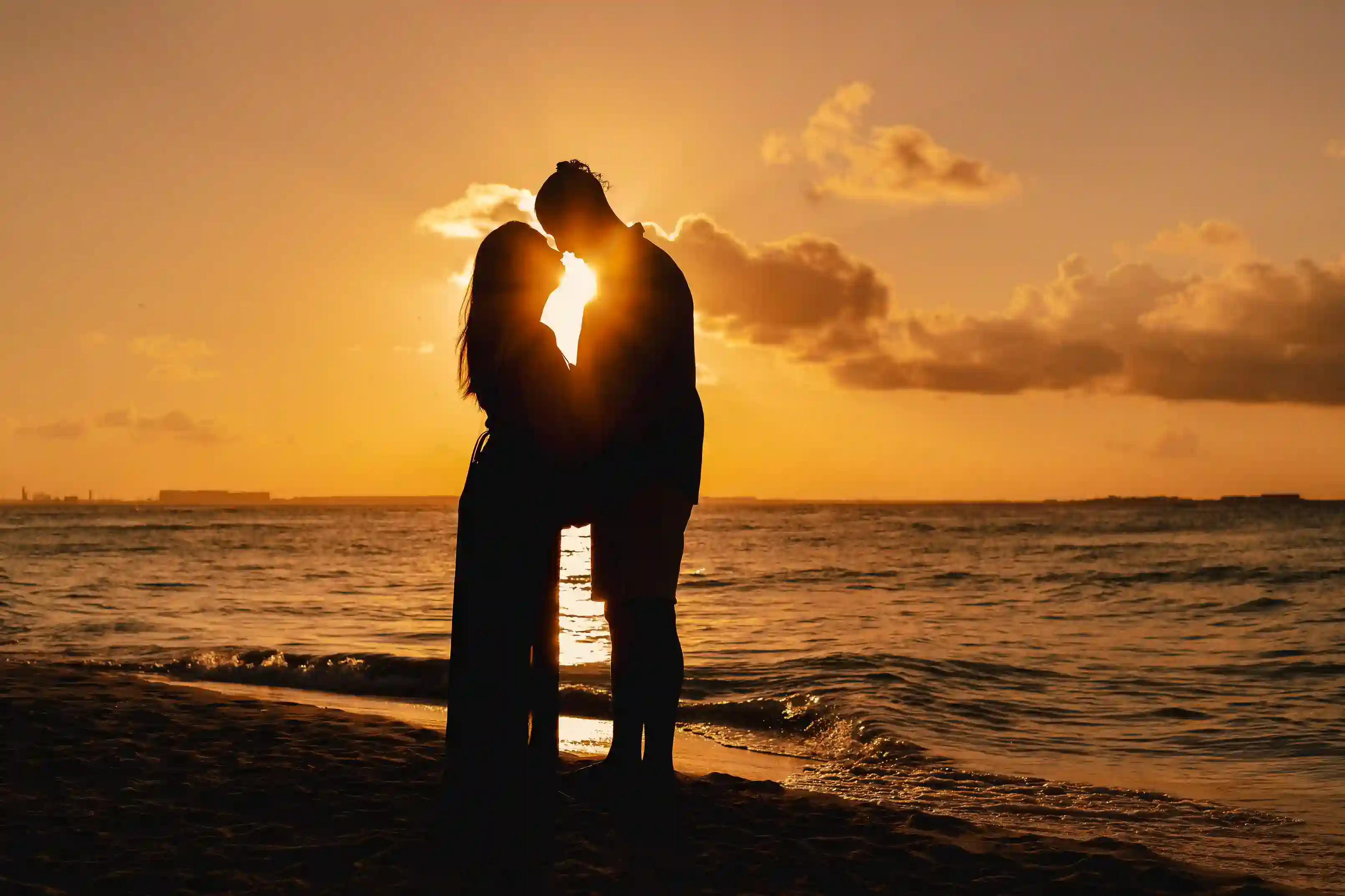 Couple walking together on a Caribbean beach at sunset