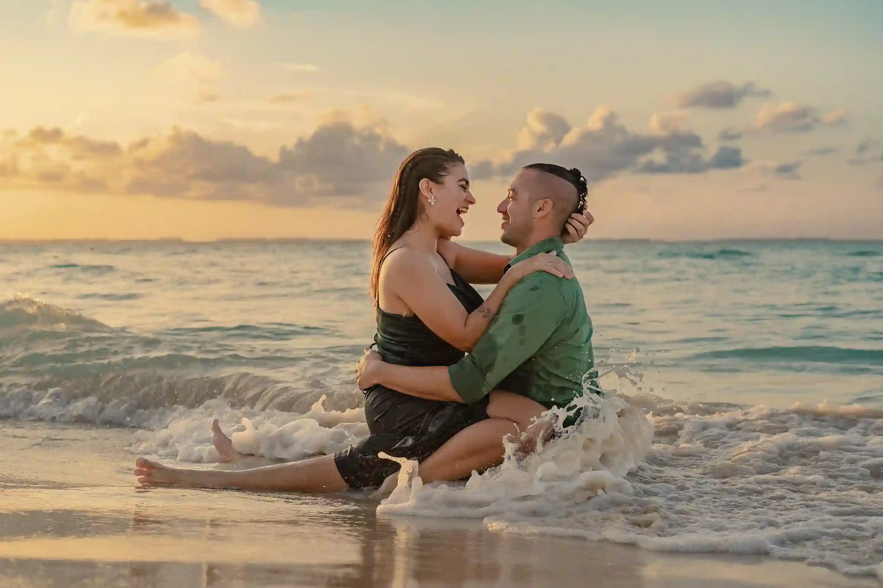 Couple walking on beach at sunset during Riviera Maya photoshoot, linen outfits in golden light