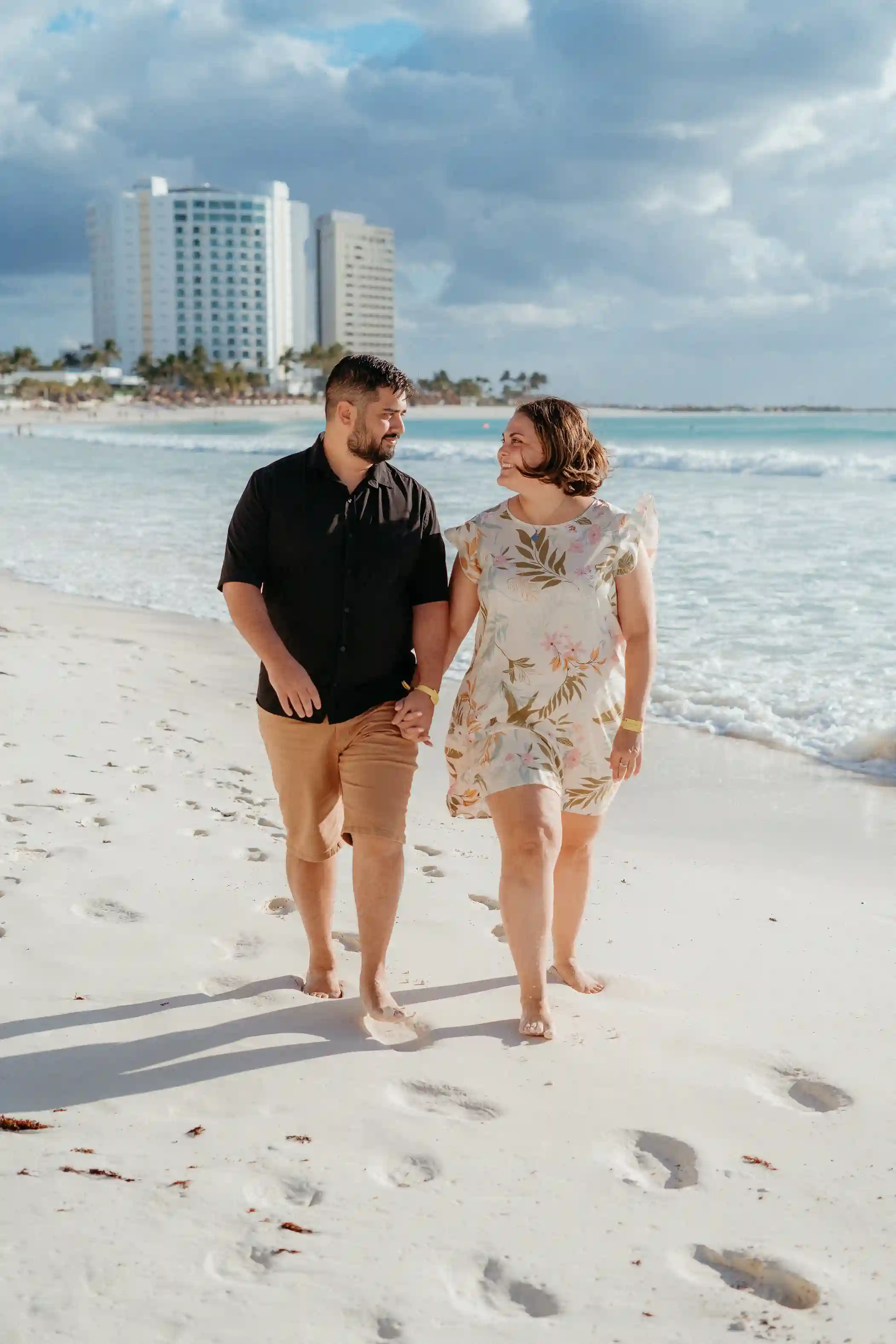Couple on a Cancún beach at golden hour during a vacation couple photoshoot