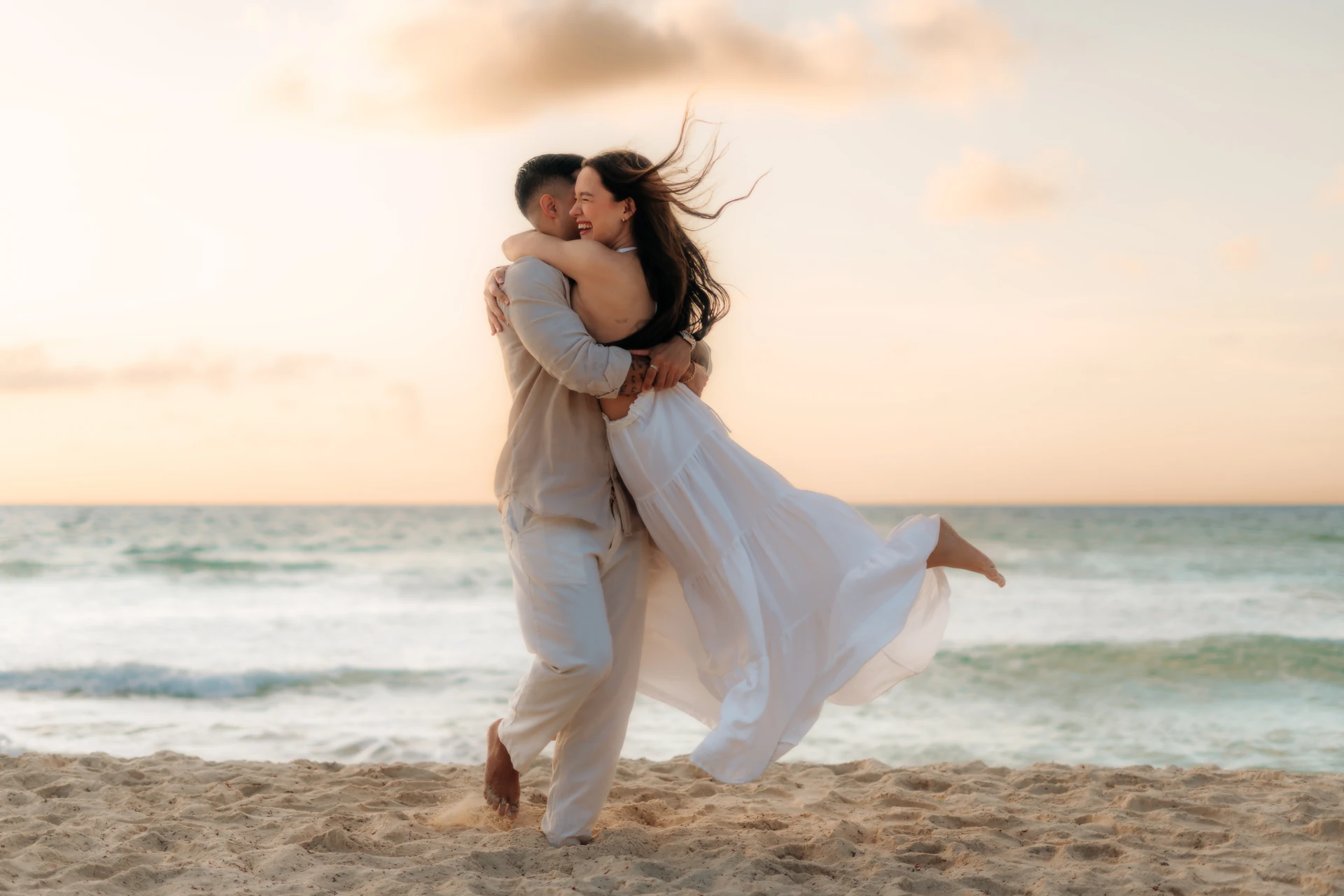 Couple embracing at sunset on a Cozumel beach