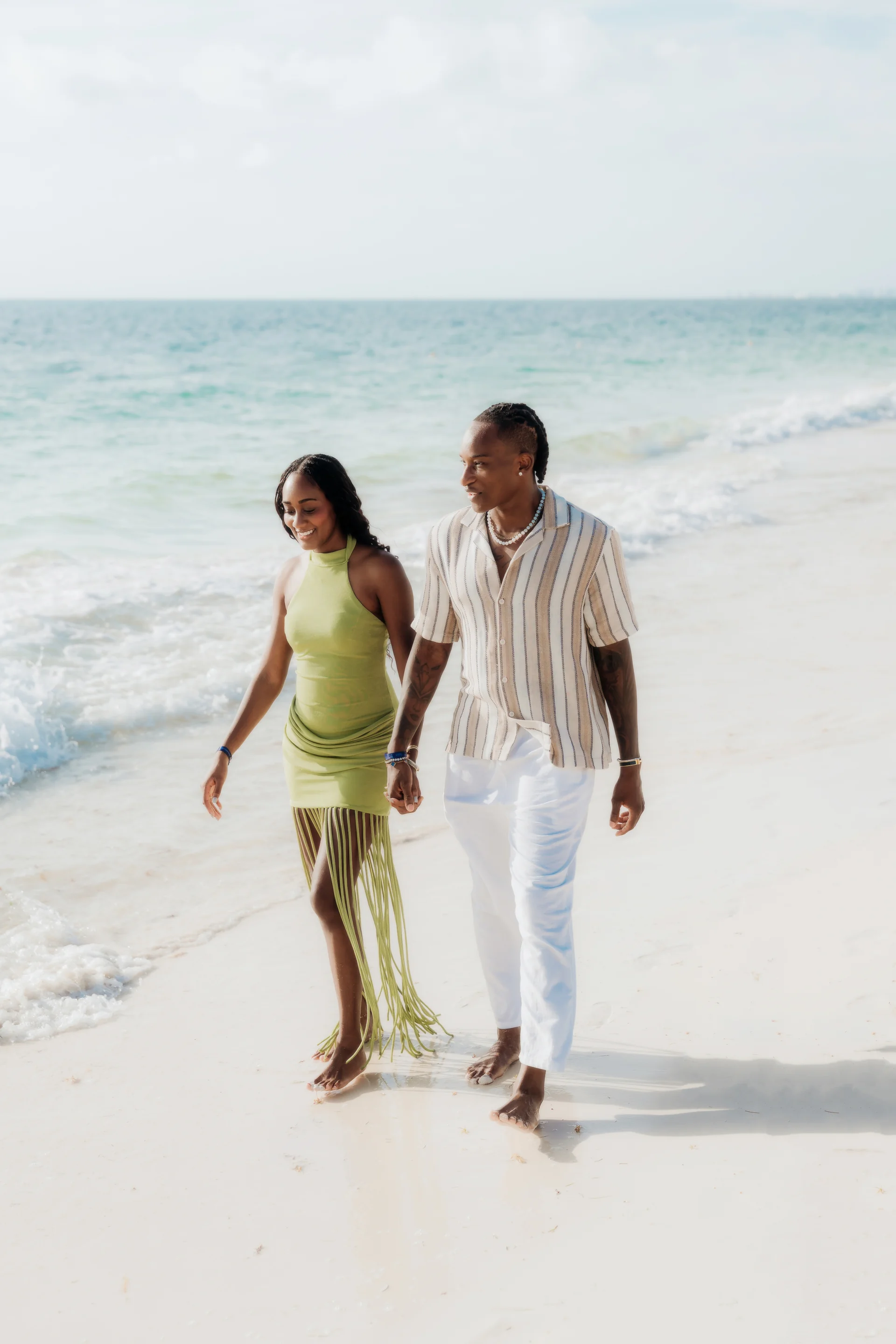 Couple holding hands and strolling barefoot along the shoreline in the morning, RIU Latino, Costa Mujeres