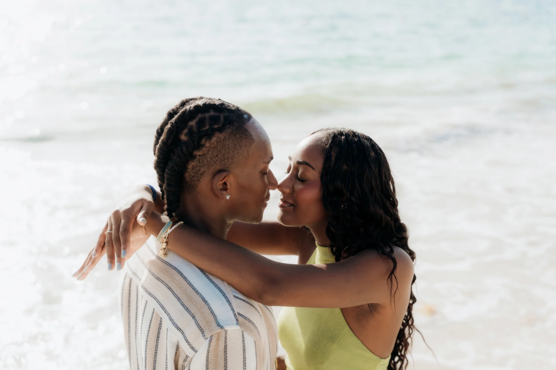 Couple sitting close at the water's edge, RIU Latino, Costa Mujeres