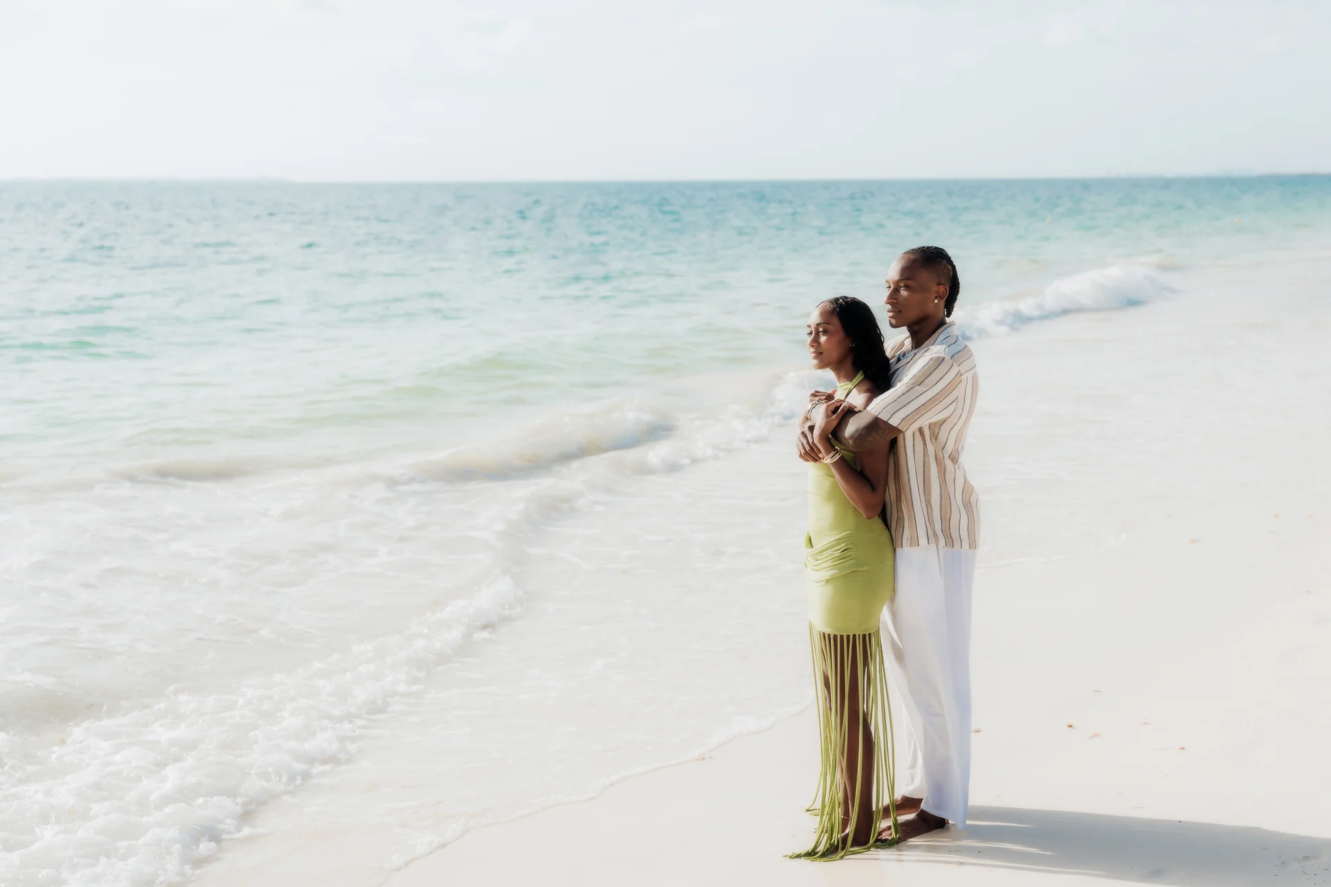 Couple laughing mid-step along the beach, RIU Latino, Costa Mujeres