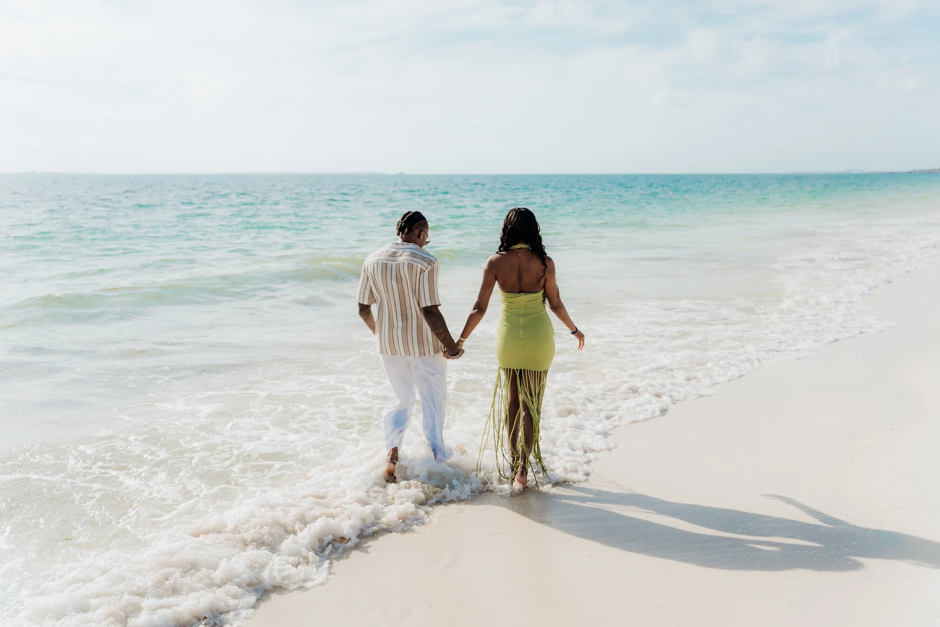 Couple standing together in the surf, RIU Latino, Costa Mujeres