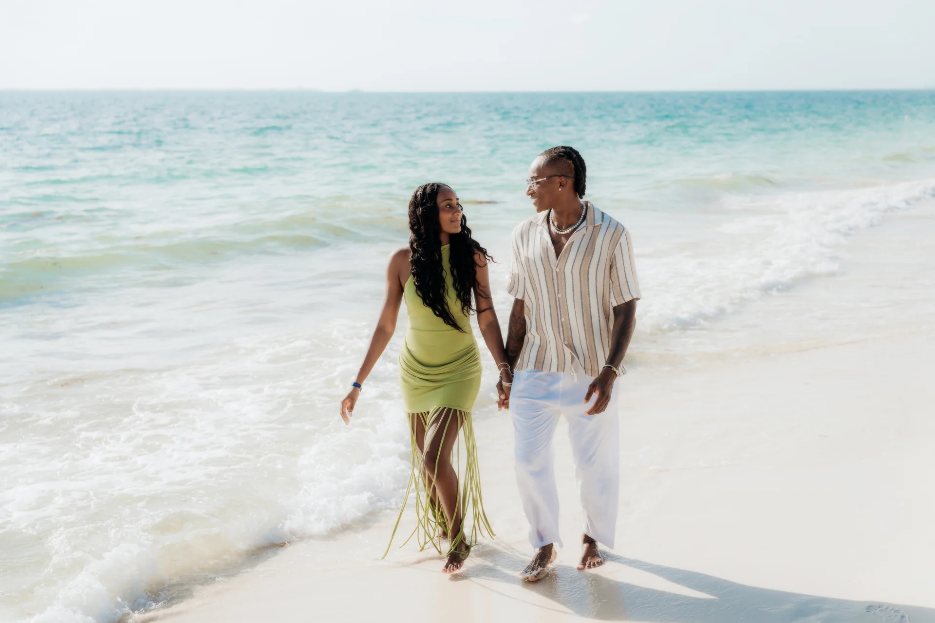 Couple sharing a laugh on the sand, RIU Latino, Costa Mujeres