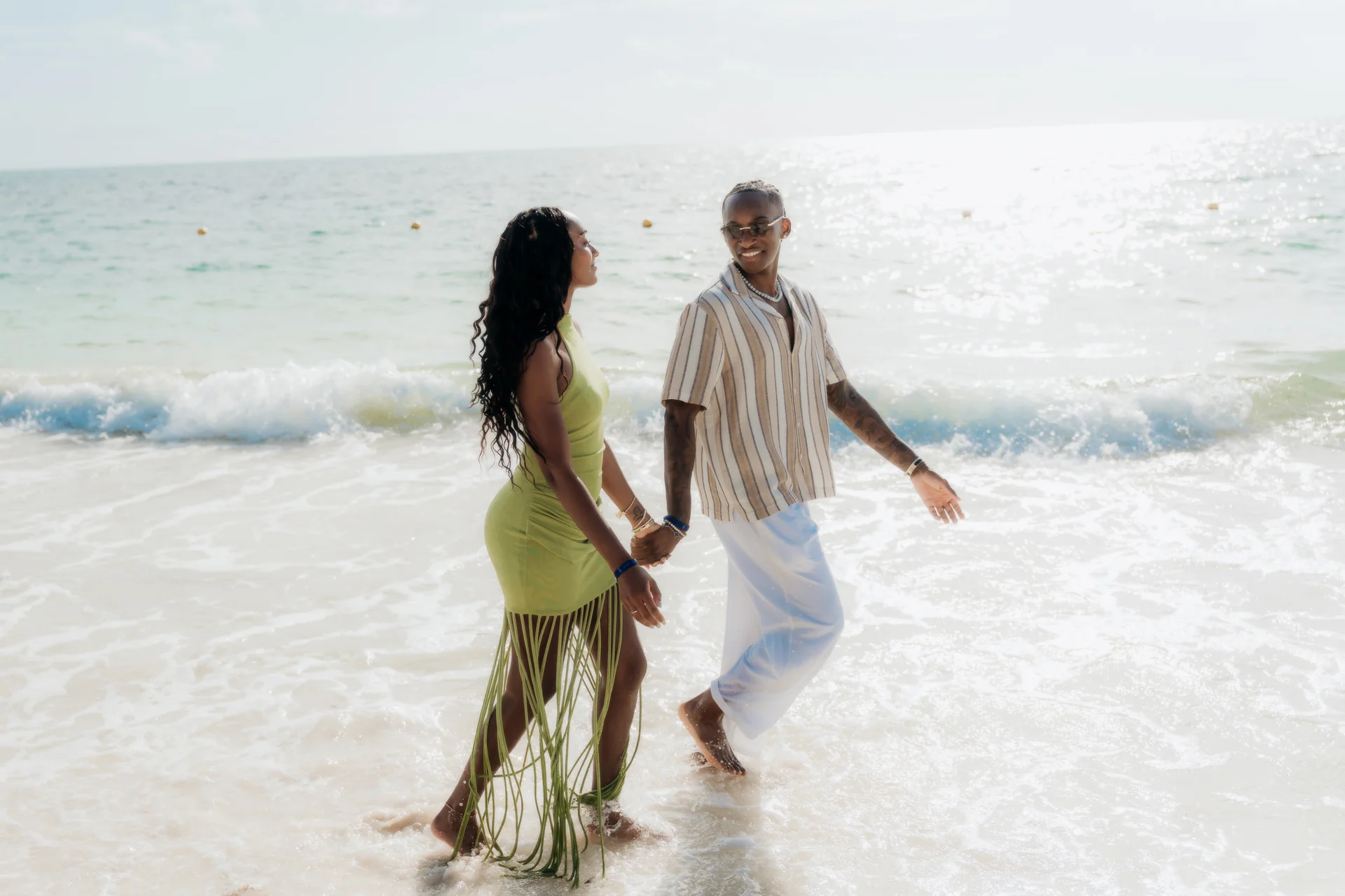 Couple embracing as the tide comes in, RIU Latino, Costa Mujeres