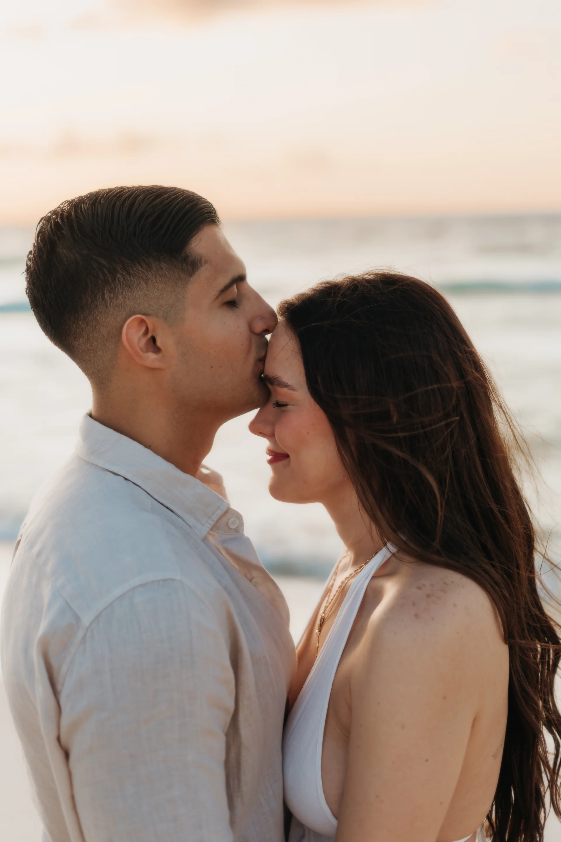 Couple embracing beneath the open sky, Playa Delfines, Cancún