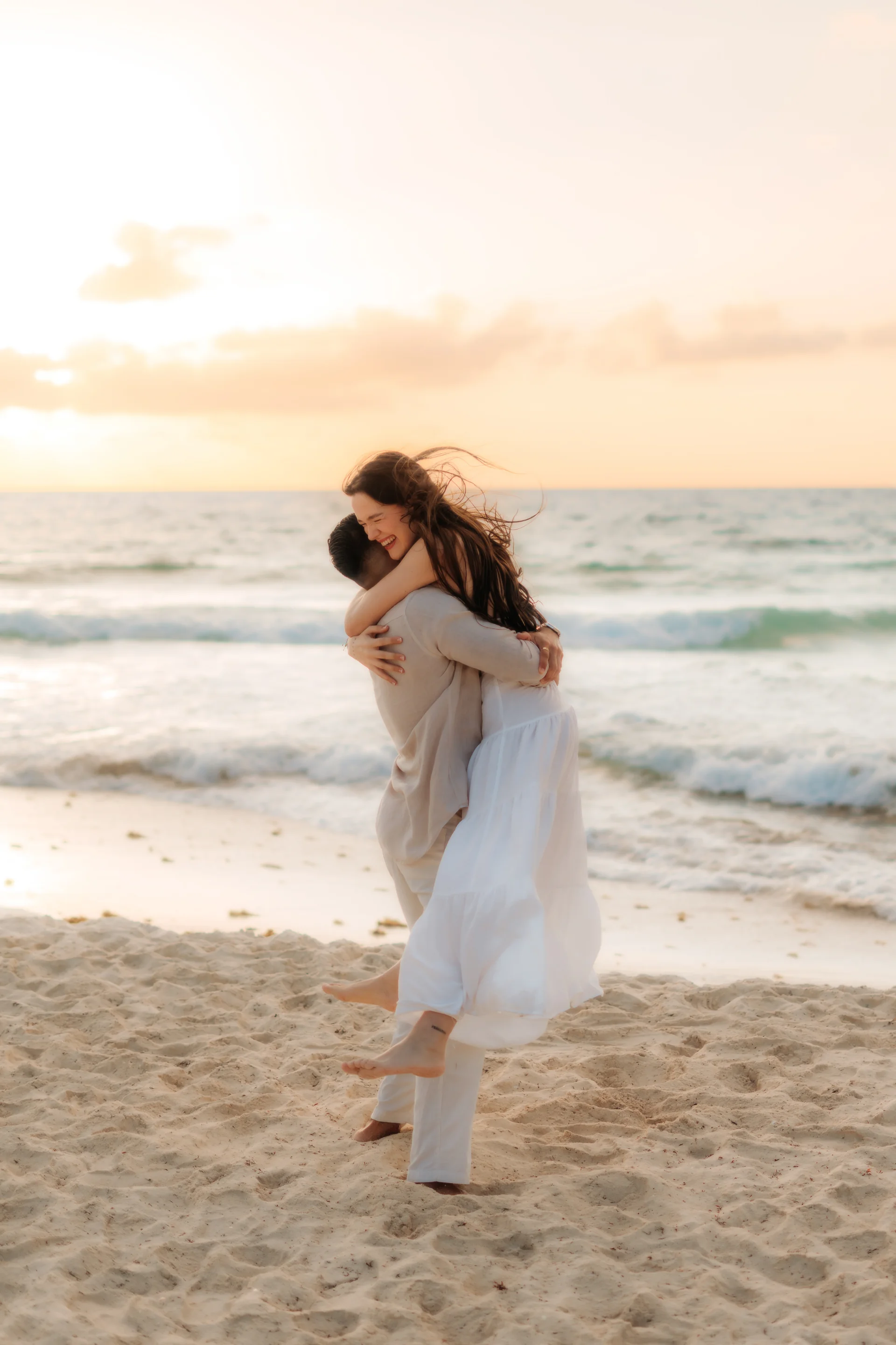 Couple smiling in each other's arms, Playa Delfines, Cancún