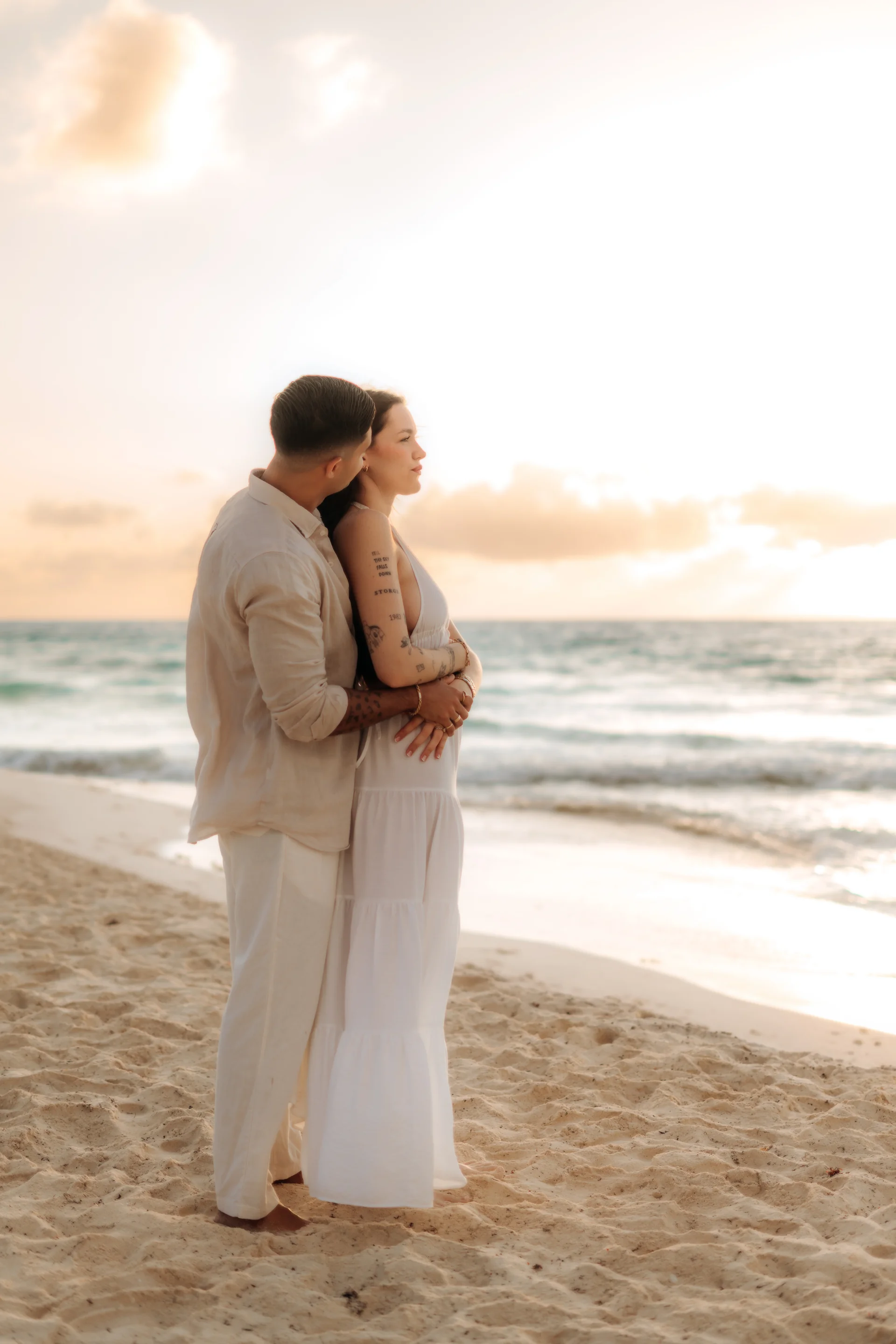 Couple standing together in the surf, Playa Delfines, Cancún