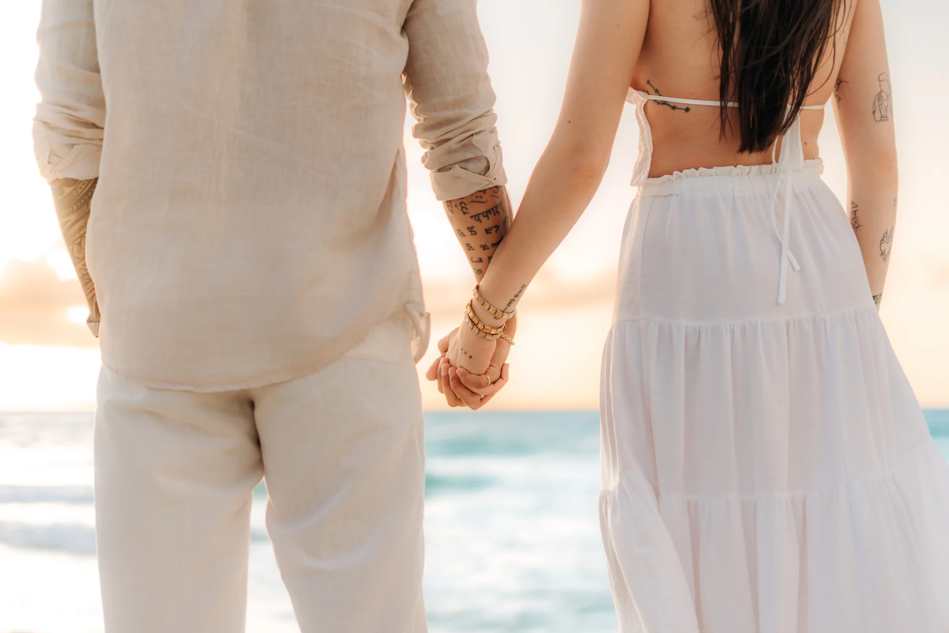 Couple wrapped together at the shoreline, Playa Delfines, Cancún