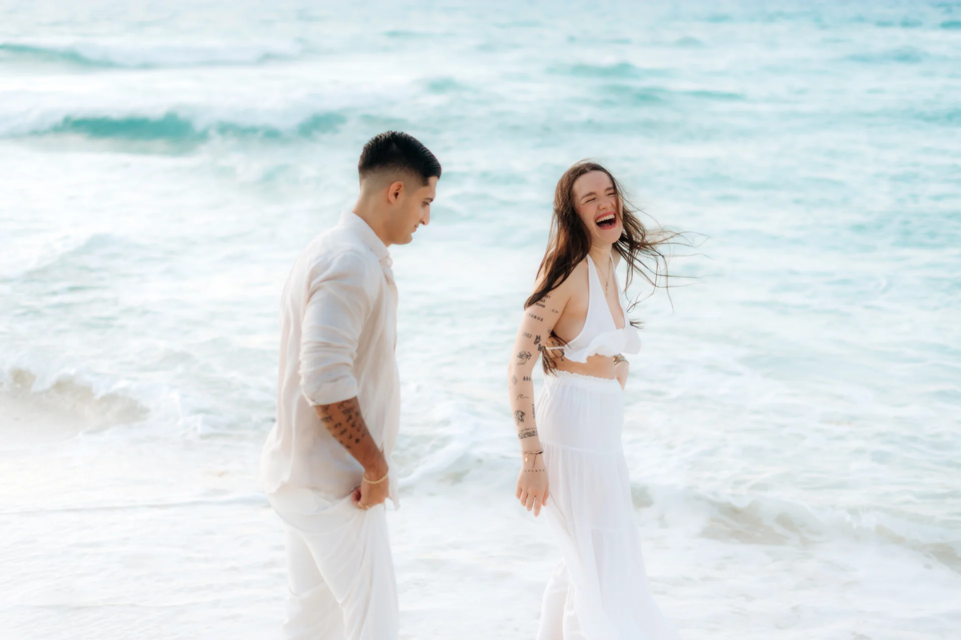 Couple holding each other under the palms, Playa Delfines, Cancún