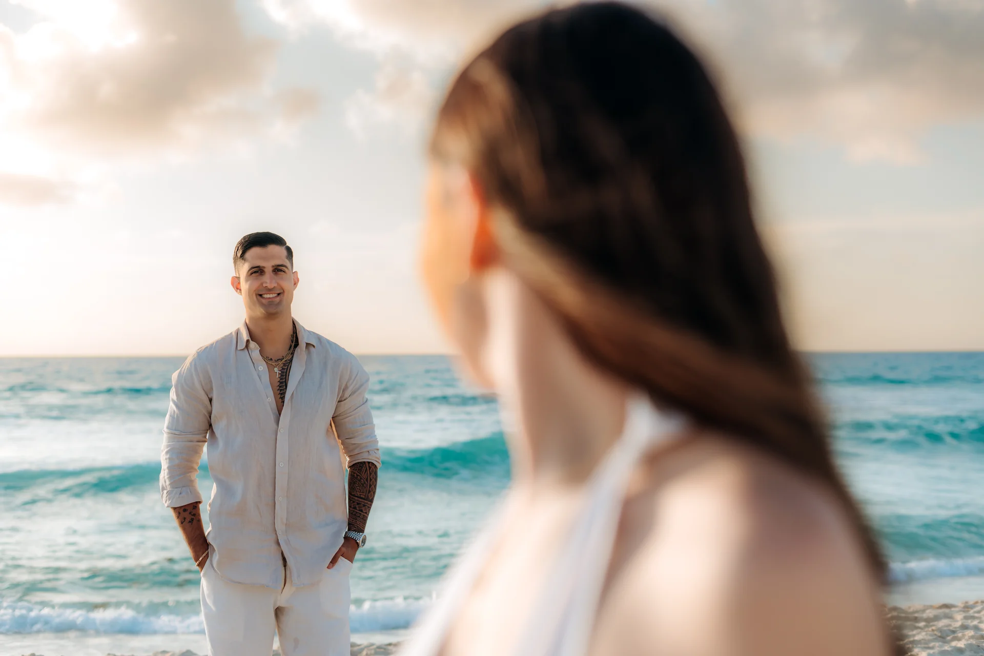 Couple walking hand in hand along the shore, Playa Delfines, Cancún