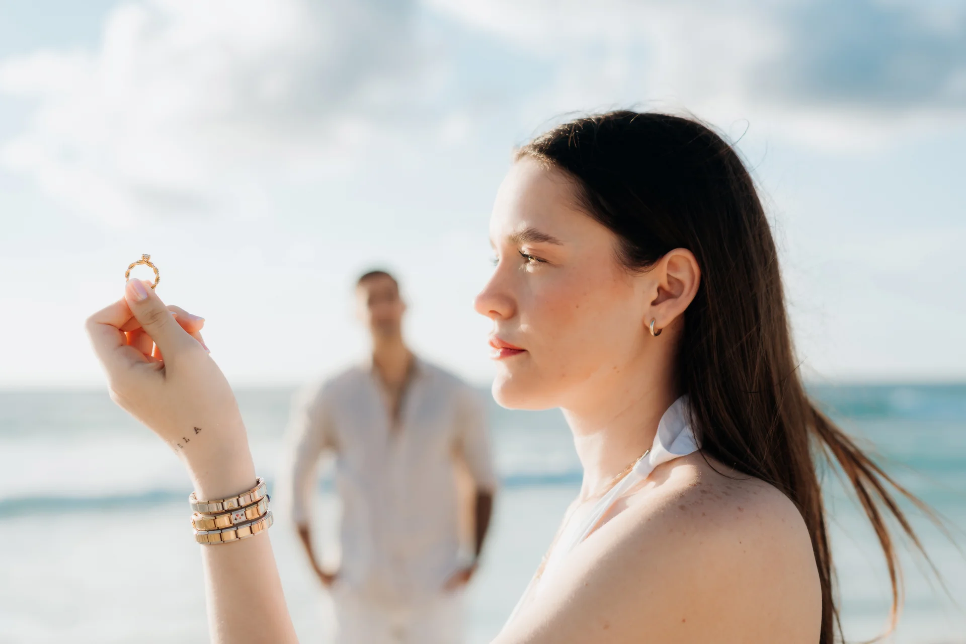Couple embracing at the water's edge, Playa Delfines, Cancún