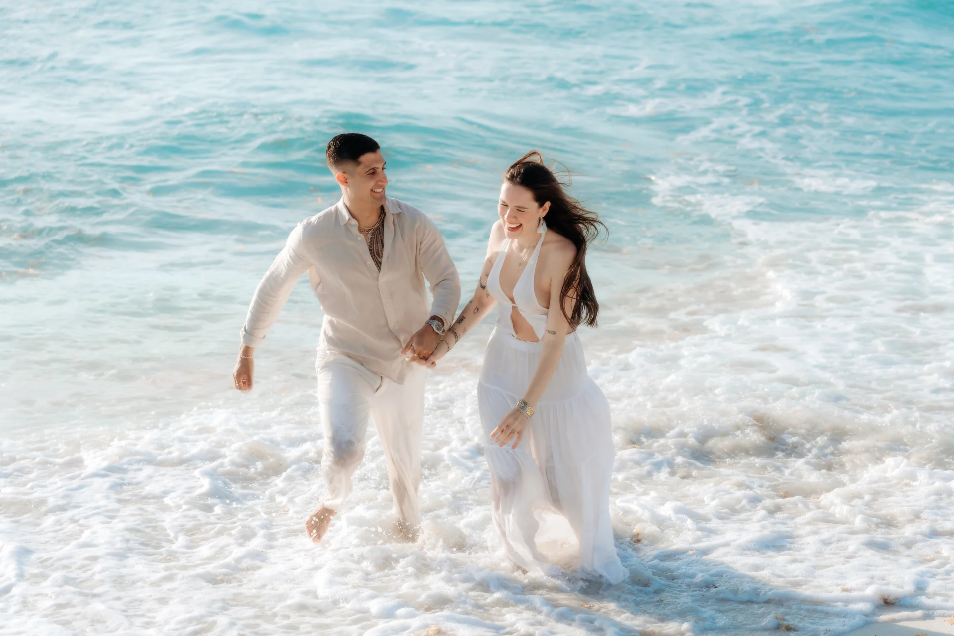Couple sharing a quiet moment on the shoreline, Playa Delfines, Cancún