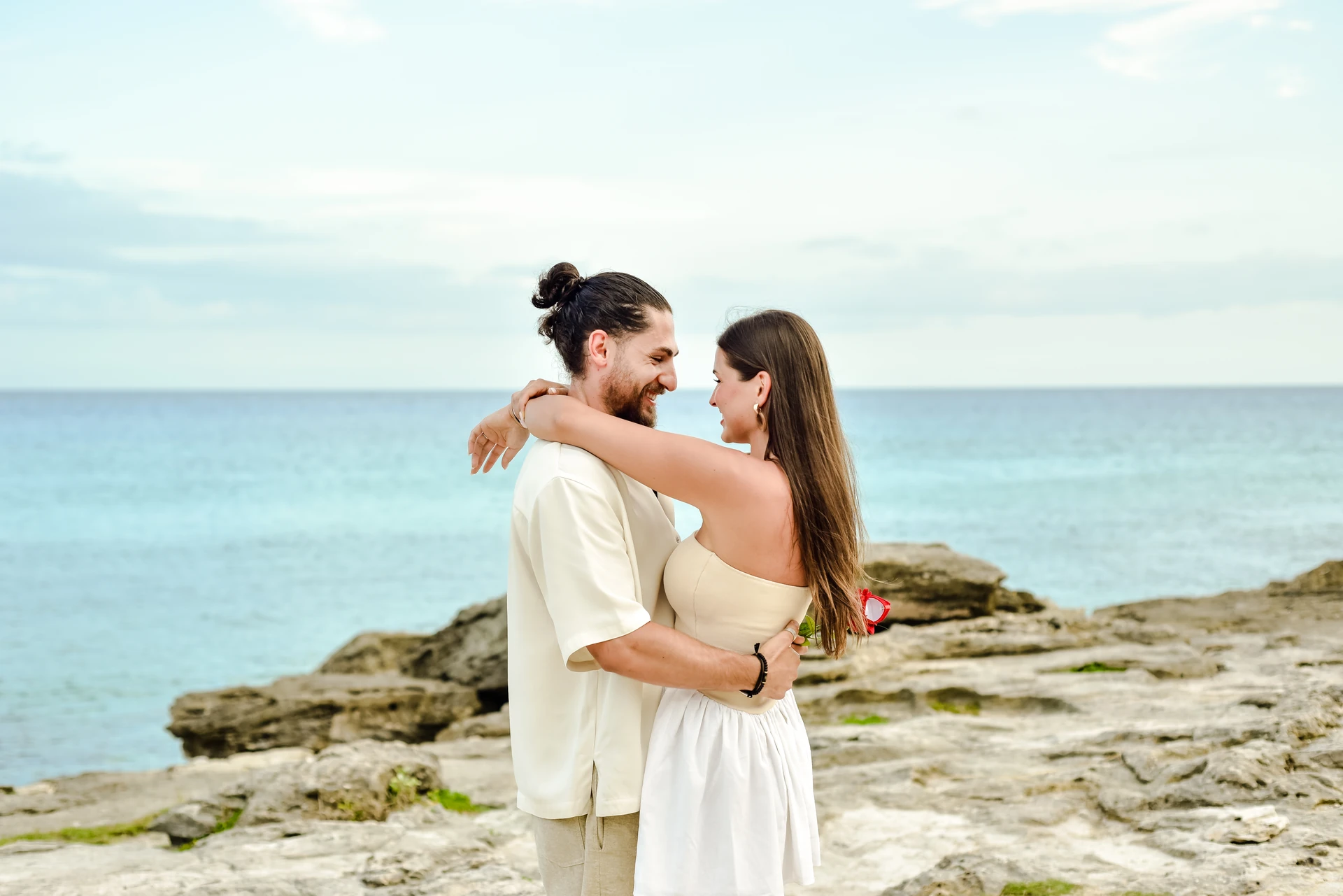 Couple along the Tulum coast with the Caribbean behind them
