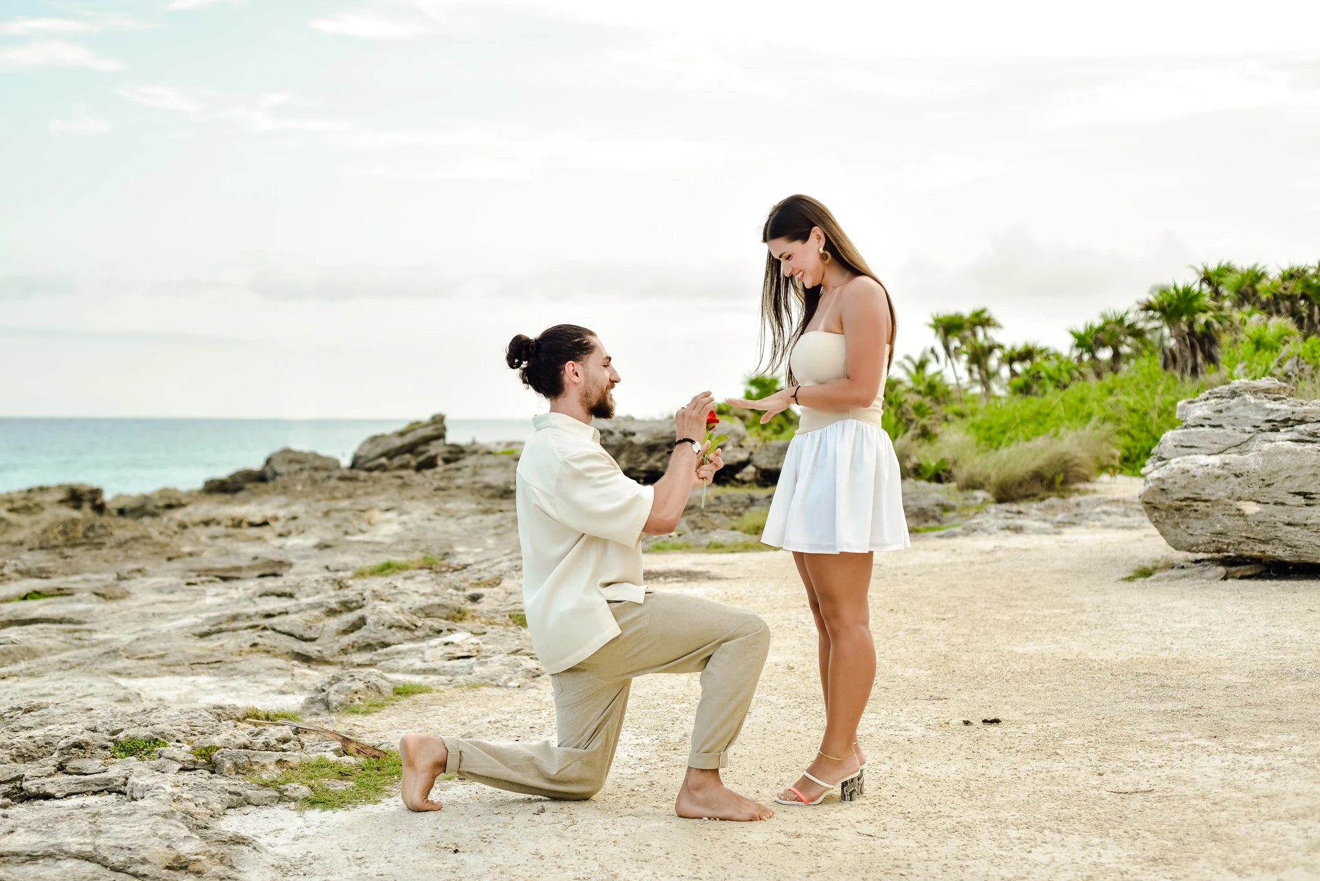Man proposing to his partner on the Tulum coast at golden hour