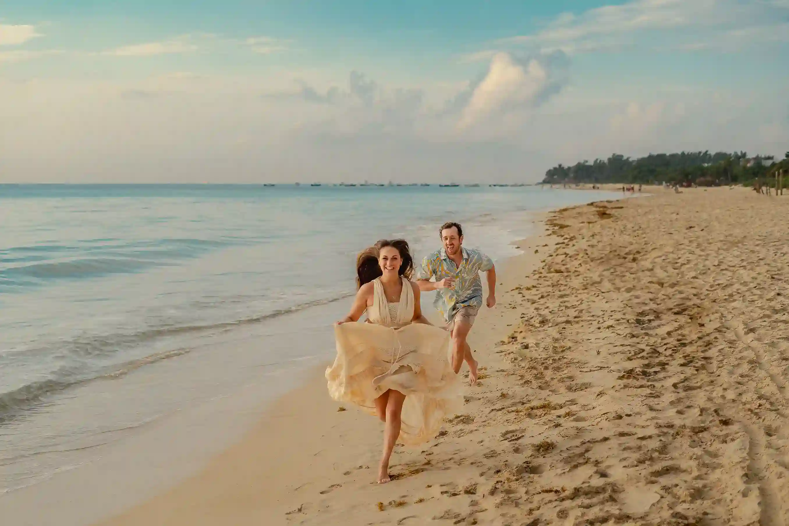 Couple laughing together by the water in the morning, Cancún