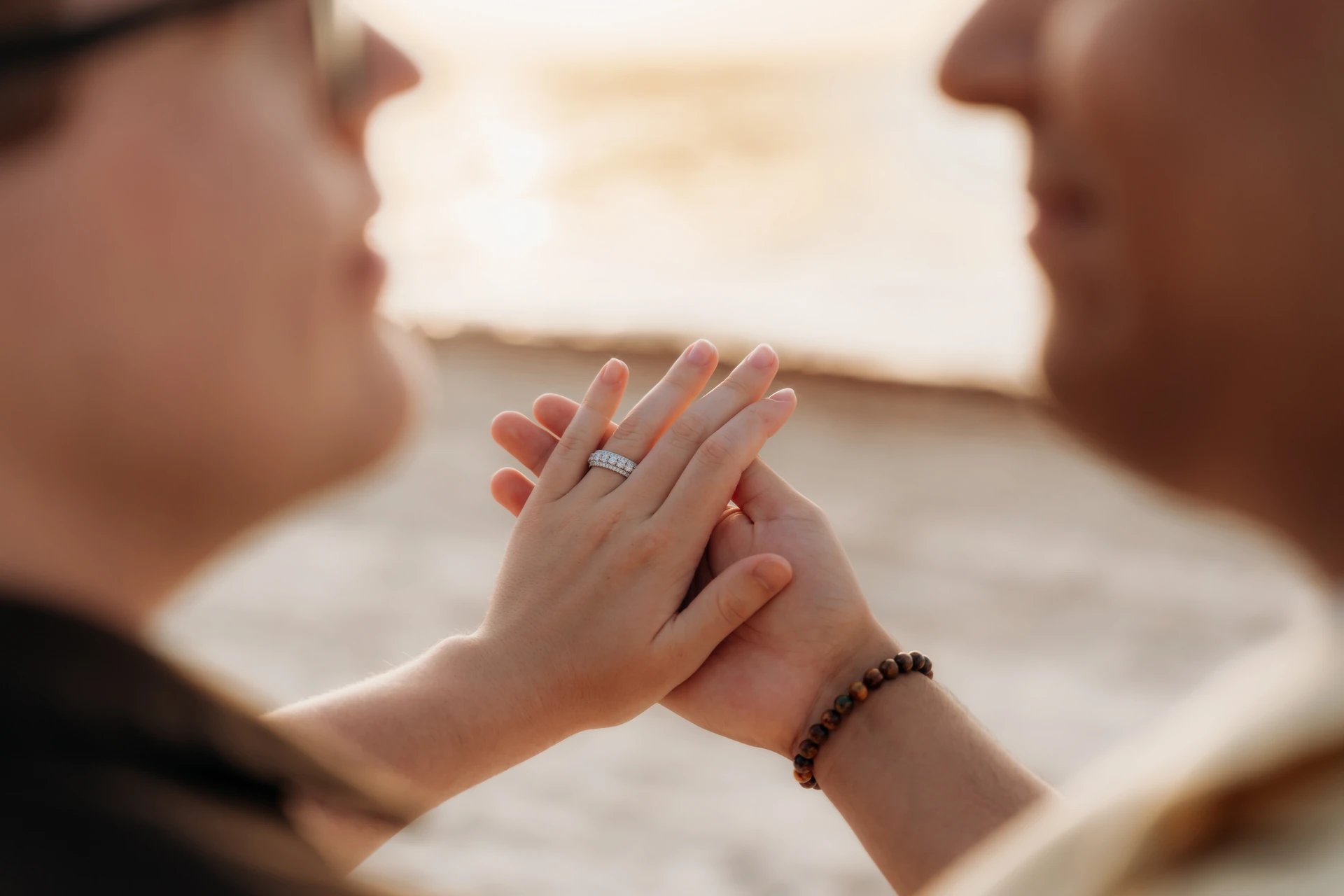 Couple holding hands with an engagement ring in the Riviera Maya