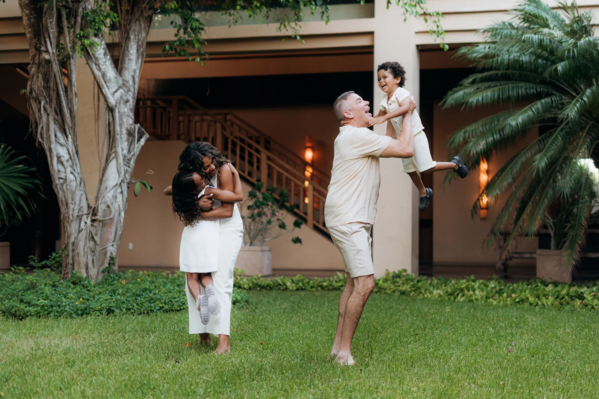 Family laughing at a shared joke on the beach, Banyan Tree Mayakoba, Riviera Maya