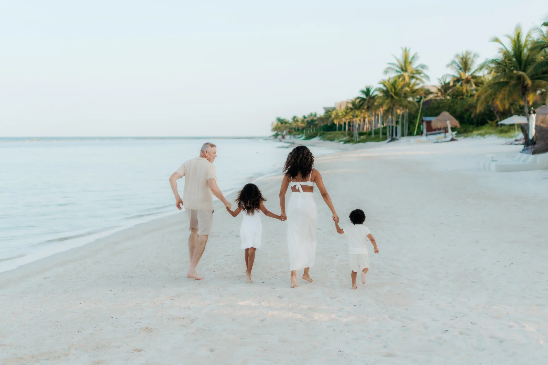 Family laughing together on the sand, Banyan Tree Mayakoba, Riviera Maya