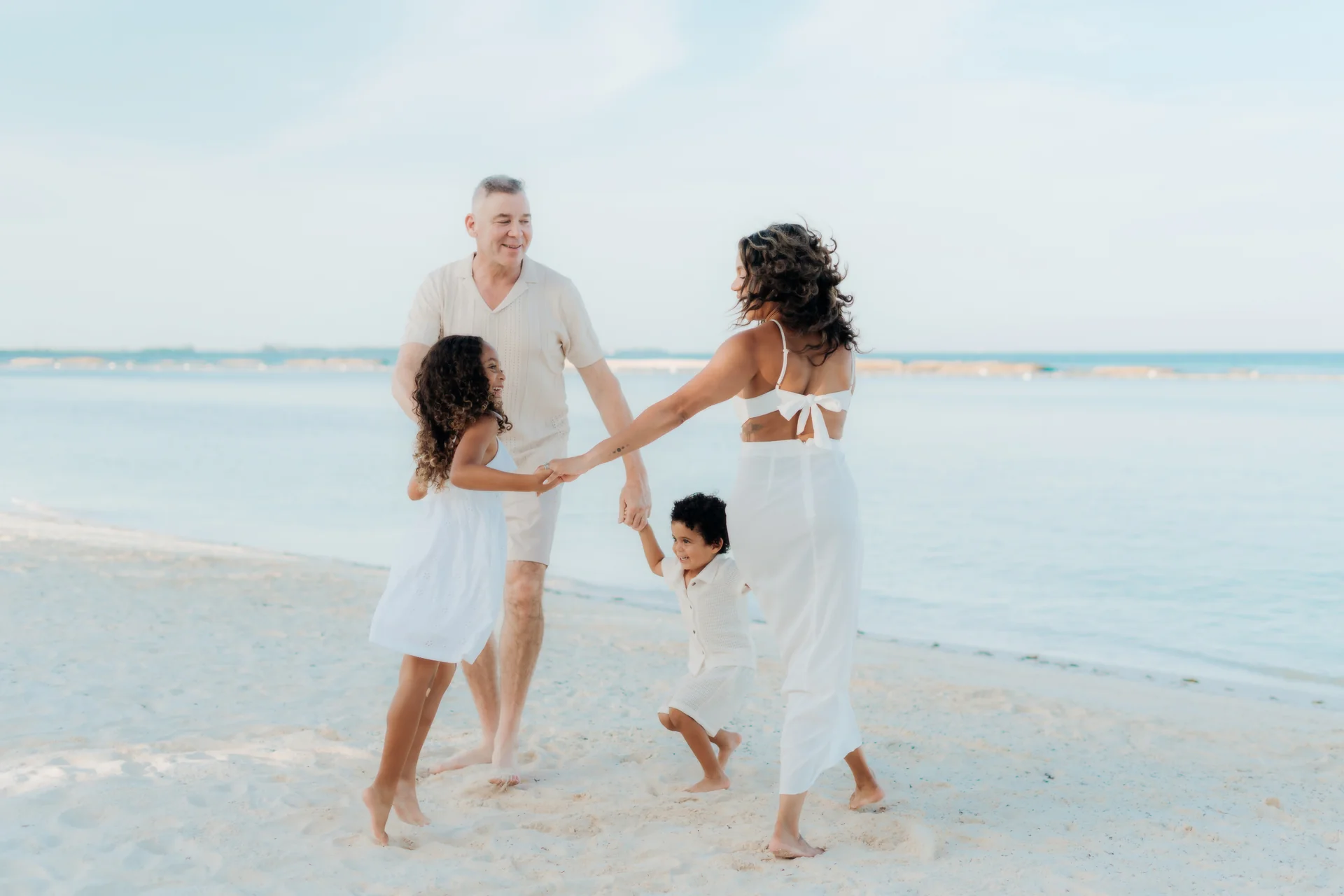Family sitting together at the water's edge, Banyan Tree Mayakoba, Riviera Maya