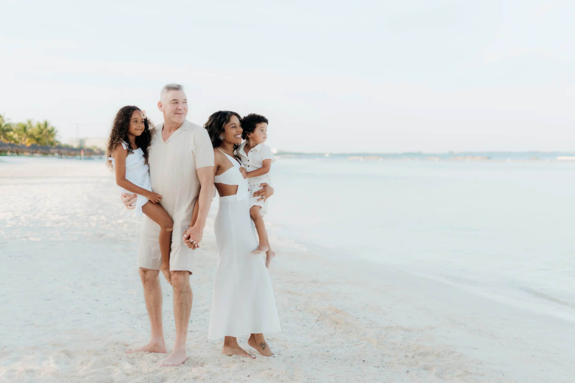 Family portrait facing the camera on the beach, Banyan Tree Mayakoba, Riviera Maya