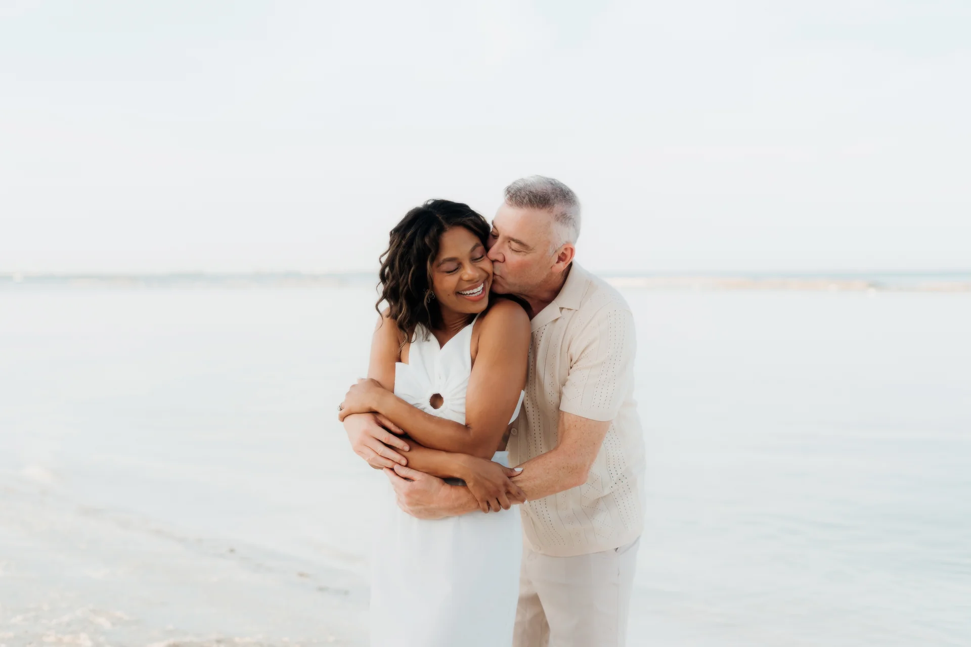 Family embracing on the sand, Banyan Tree Mayakoba, Riviera Maya