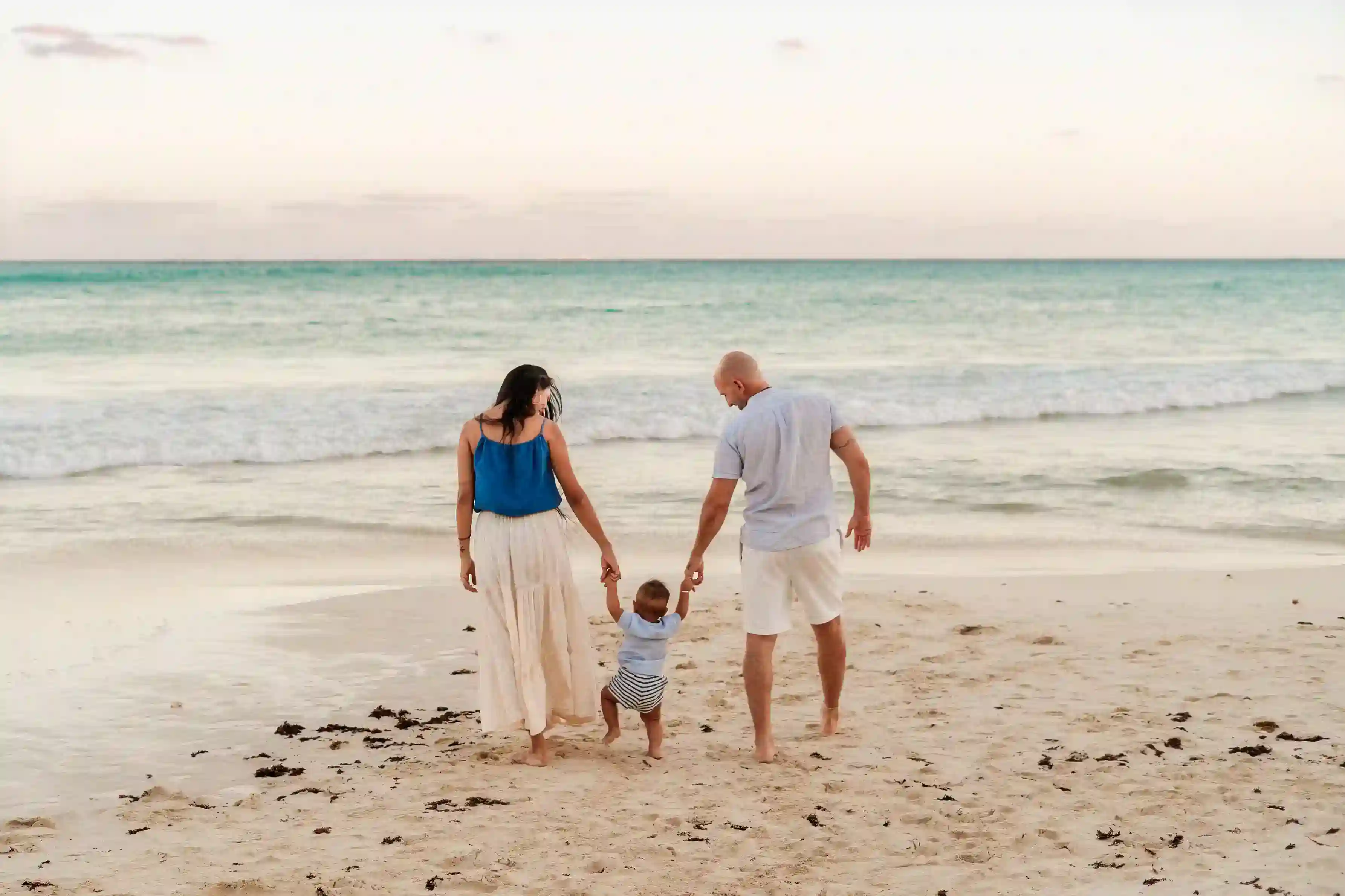 Family with their baby on the beach, Riviera Maya