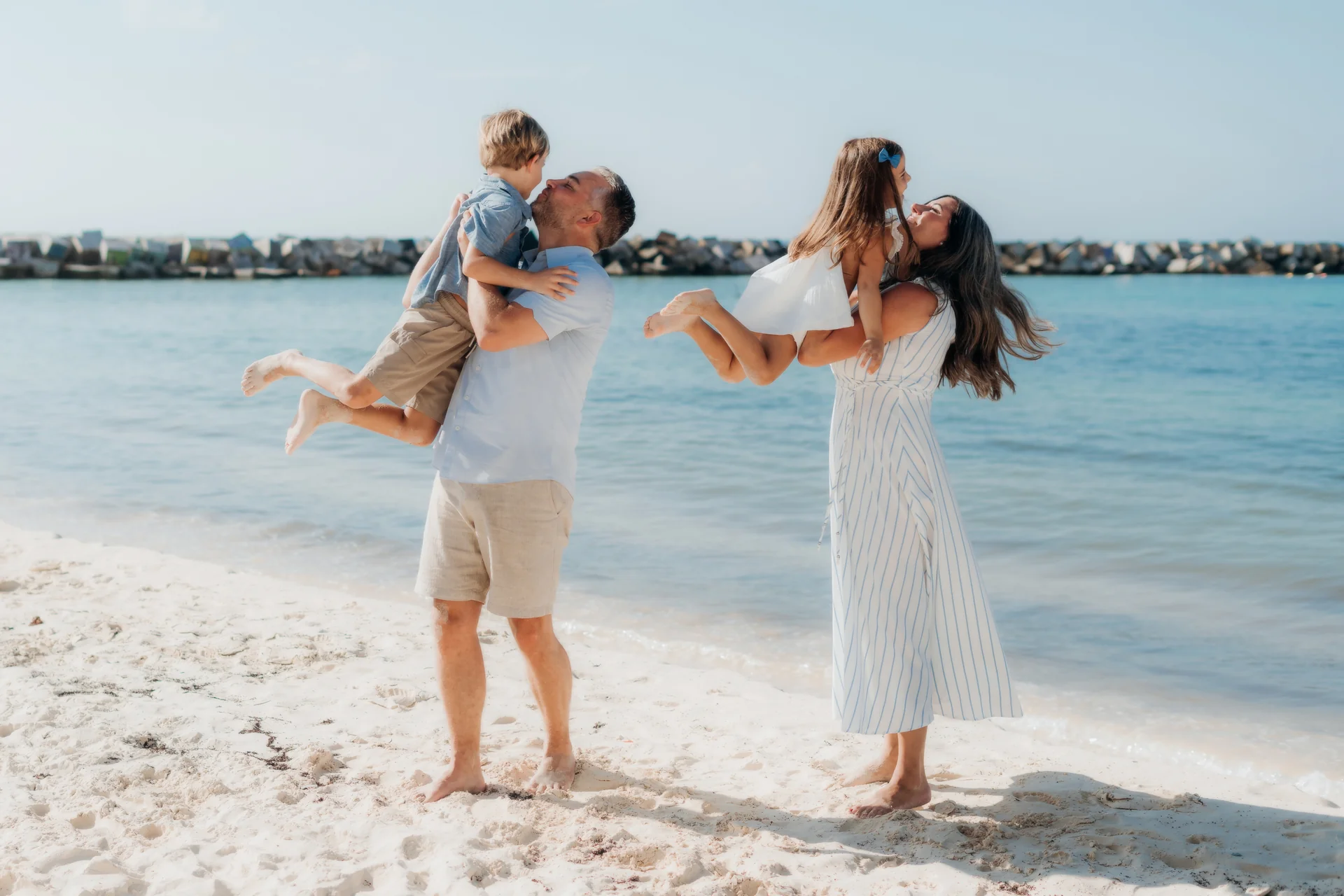 Parents swinging their child by the hands, Hyatt Ziva, Cancún