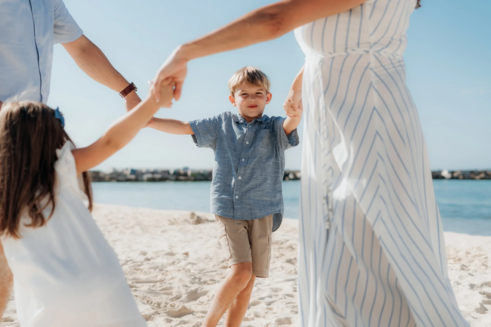 Family cuddling together at the shoreline, Hyatt Ziva, Cancún