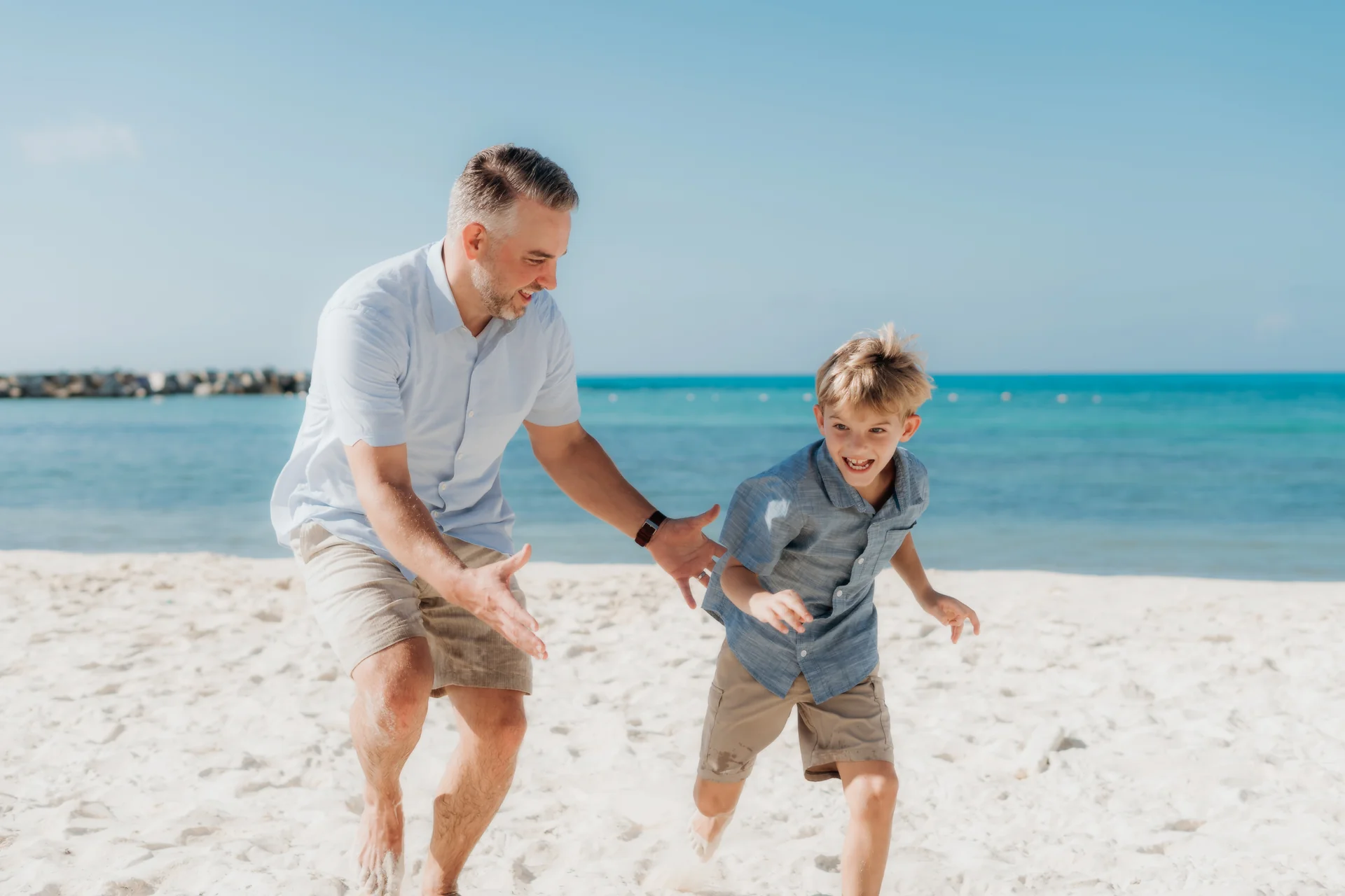 Child tossed gently into the air by a parent, Hyatt Ziva, Cancún