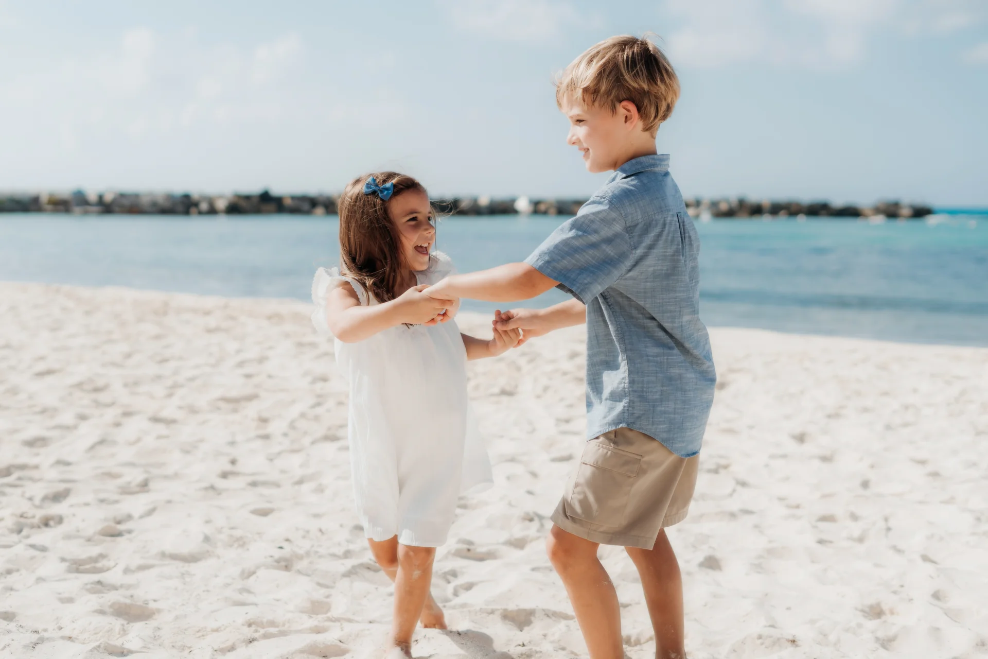 Family gathered on the sand in the early light, Hyatt Ziva, Cancún