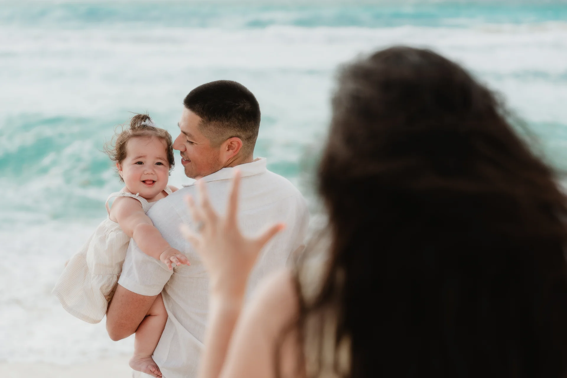 Family gathered close for a group portrait, Playa Delfines, Cancún