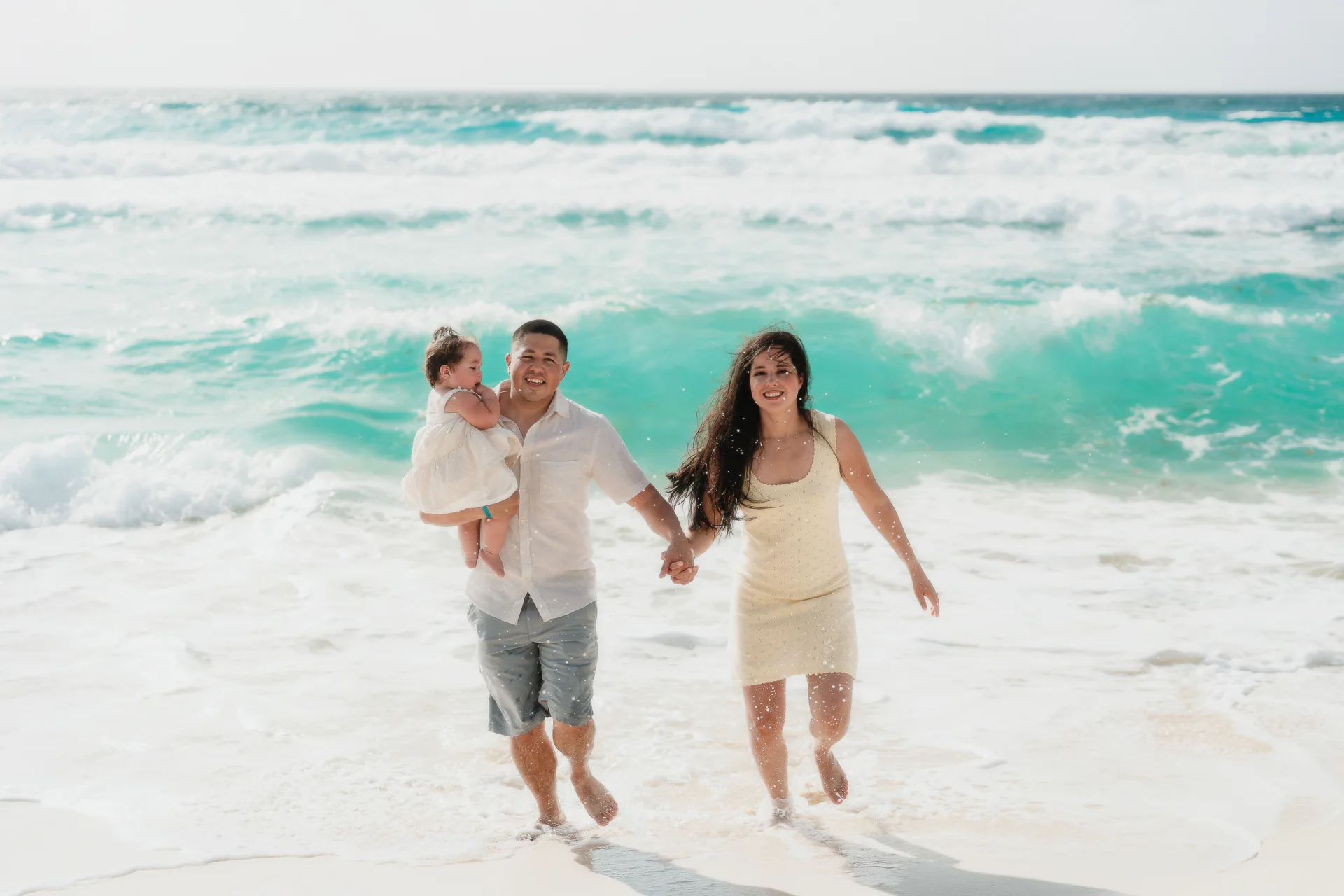 Child splashing at the water's edge, Playa Delfines, Cancún