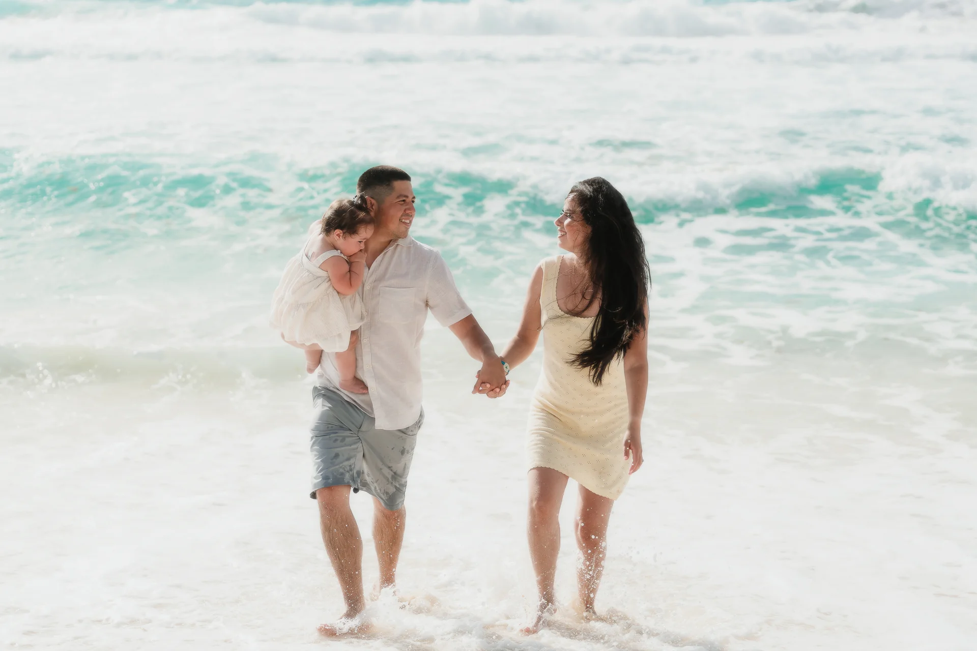 Parents twirling their child around, Playa Delfines, Cancún