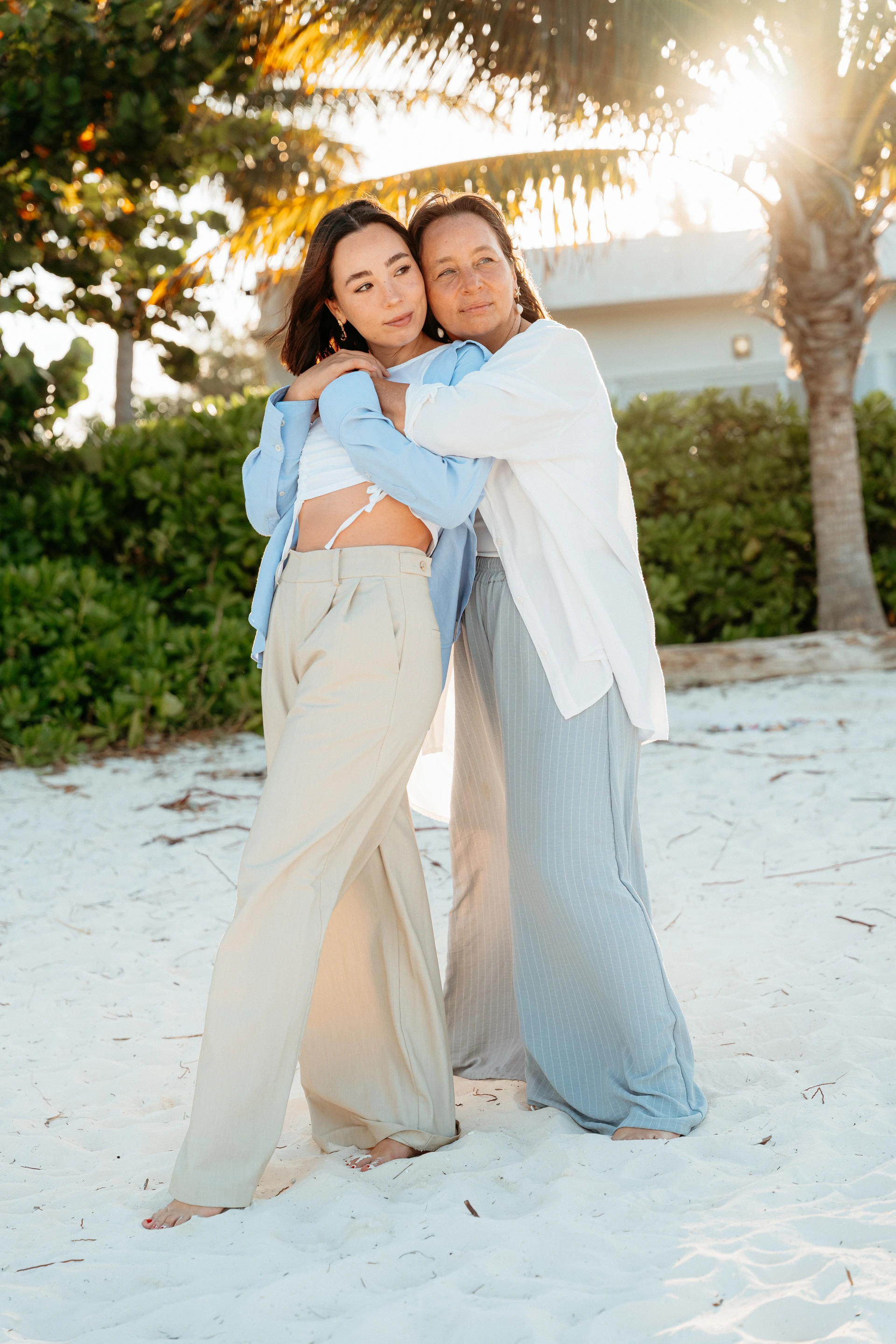 Mother and daughter embracing at sunset in Puerto Morelos