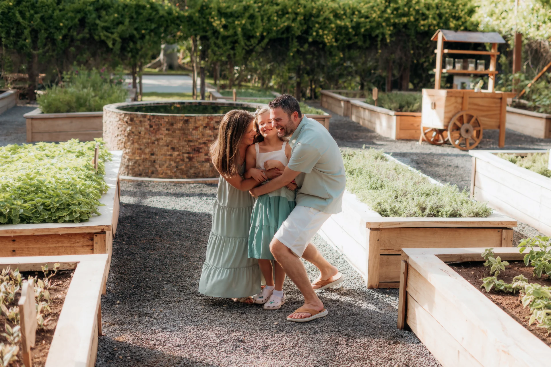 Family sharing a group hug on the sand, Rosewood Mayakoba, Riviera Maya