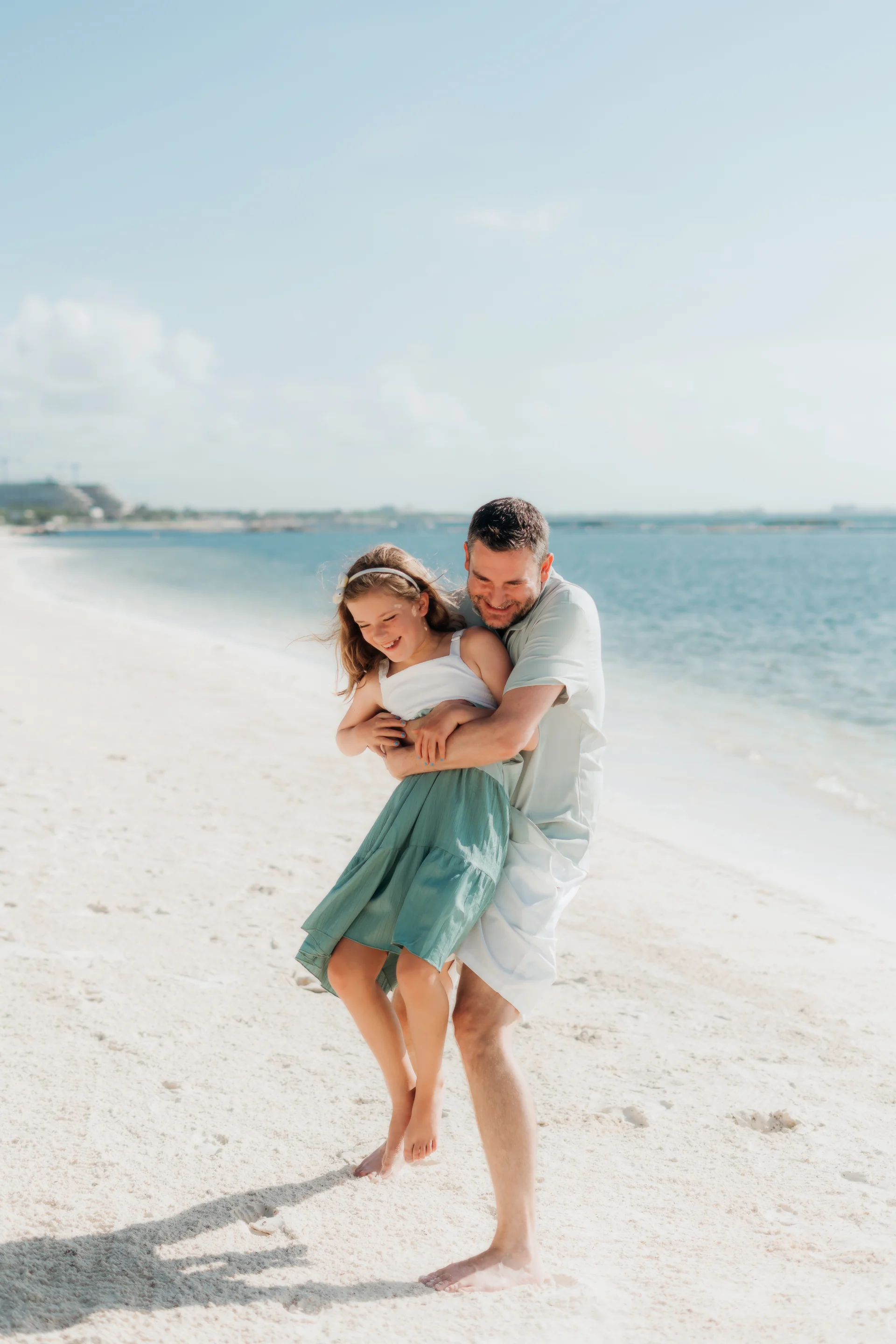 Mother holding her child close in the breeze, Rosewood Mayakoba, Riviera Maya