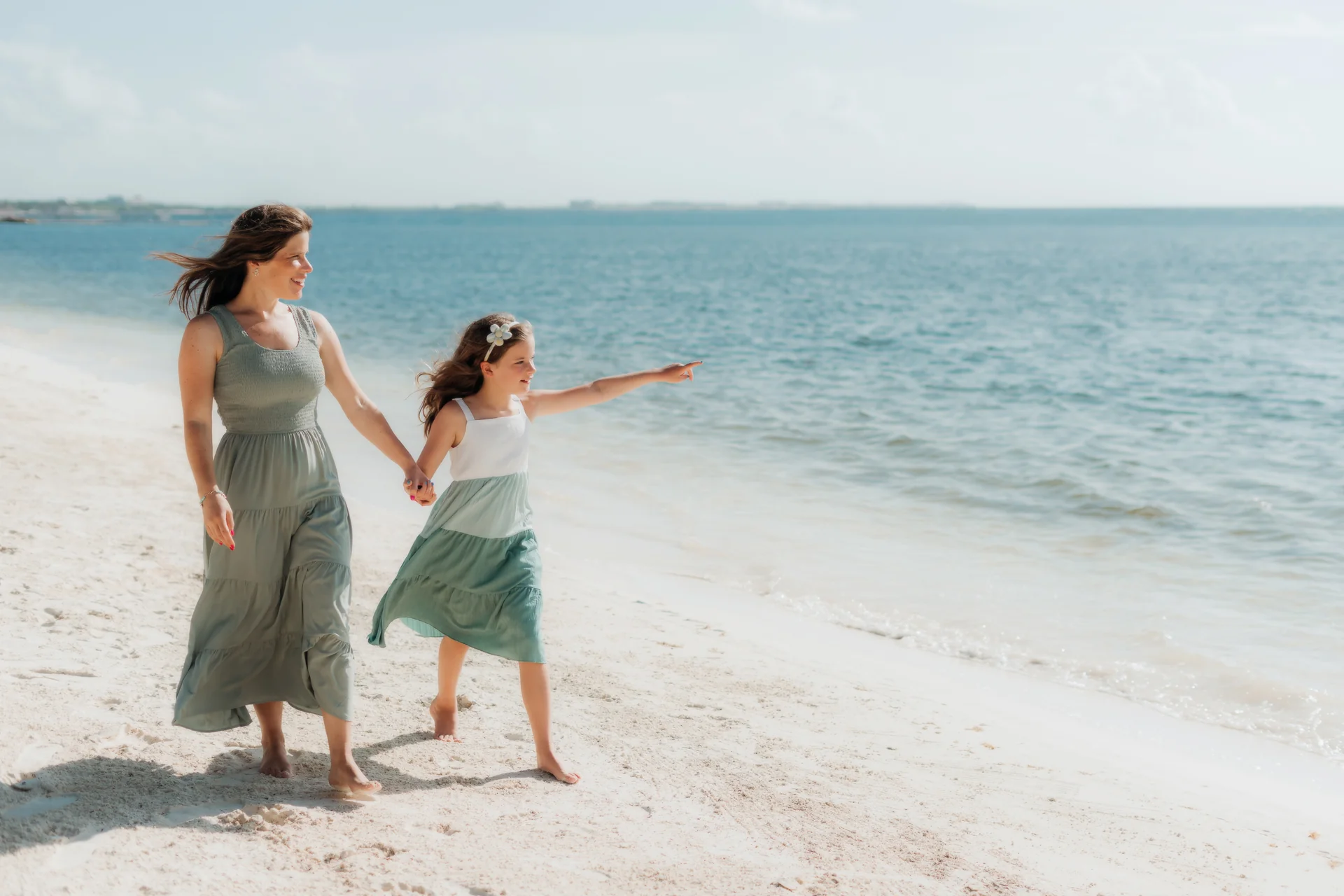 Family playing chase along the shoreline, Rosewood Mayakoba, Riviera Maya