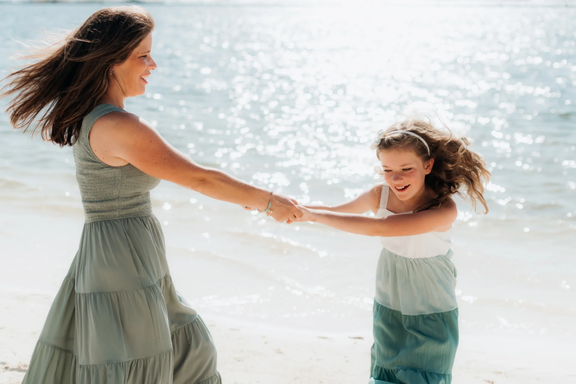 Family standing together at the water's edge, Rosewood Mayakoba, Riviera Maya
