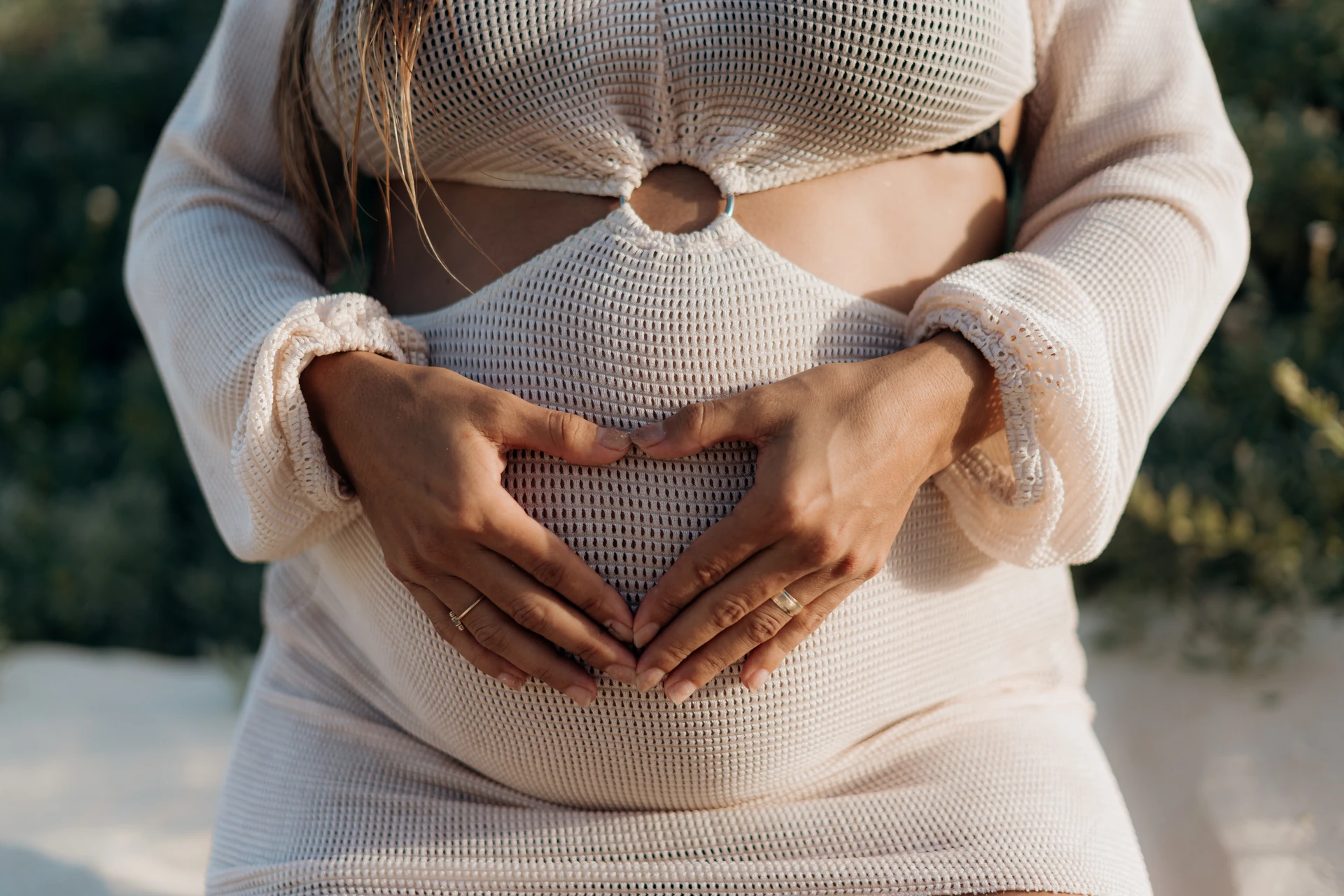 Maternity session with heart hands on the bump in Playa del Carmen