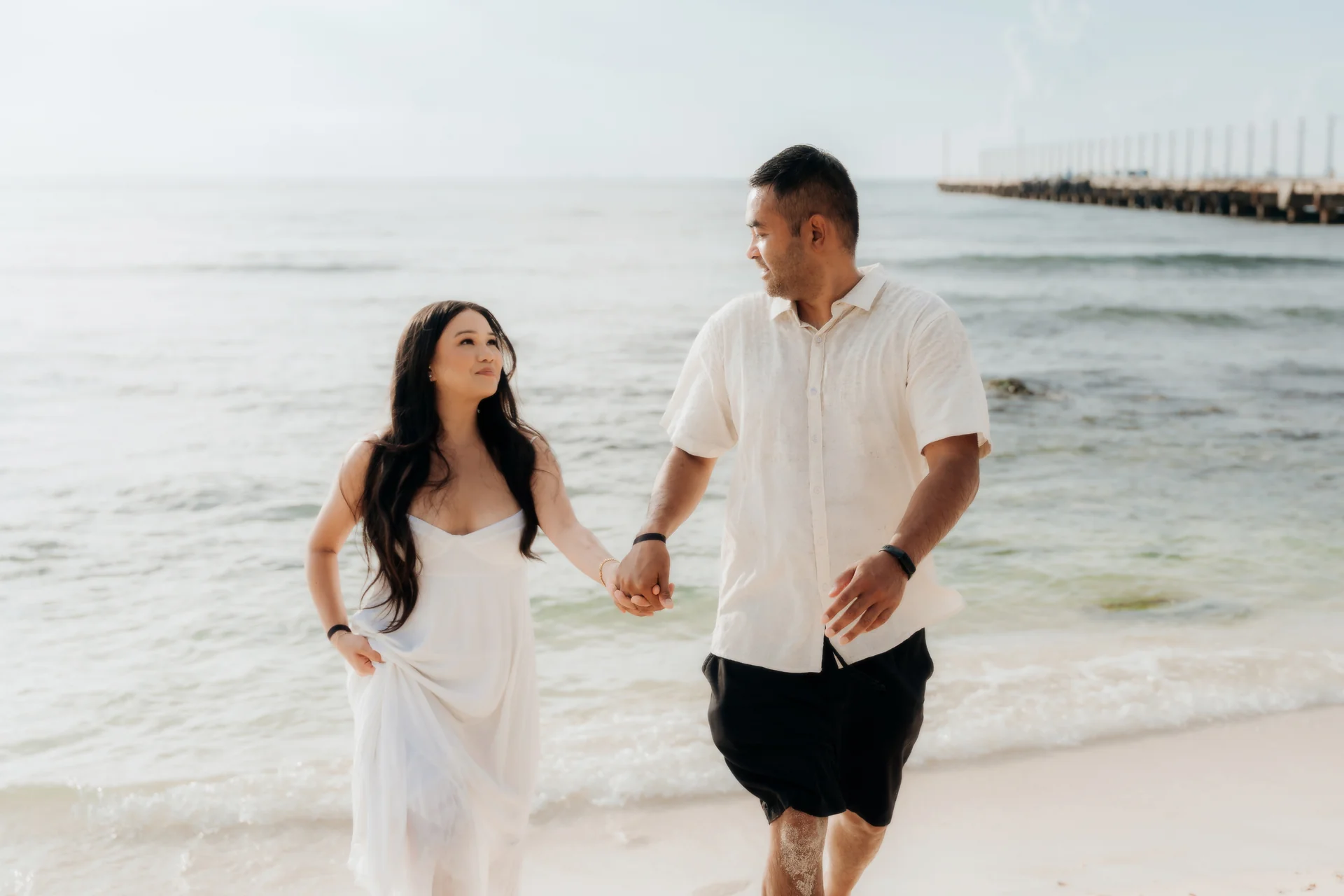 Couple celebrating on the empty beach, Hyatt Vivid, Playa del Carmen