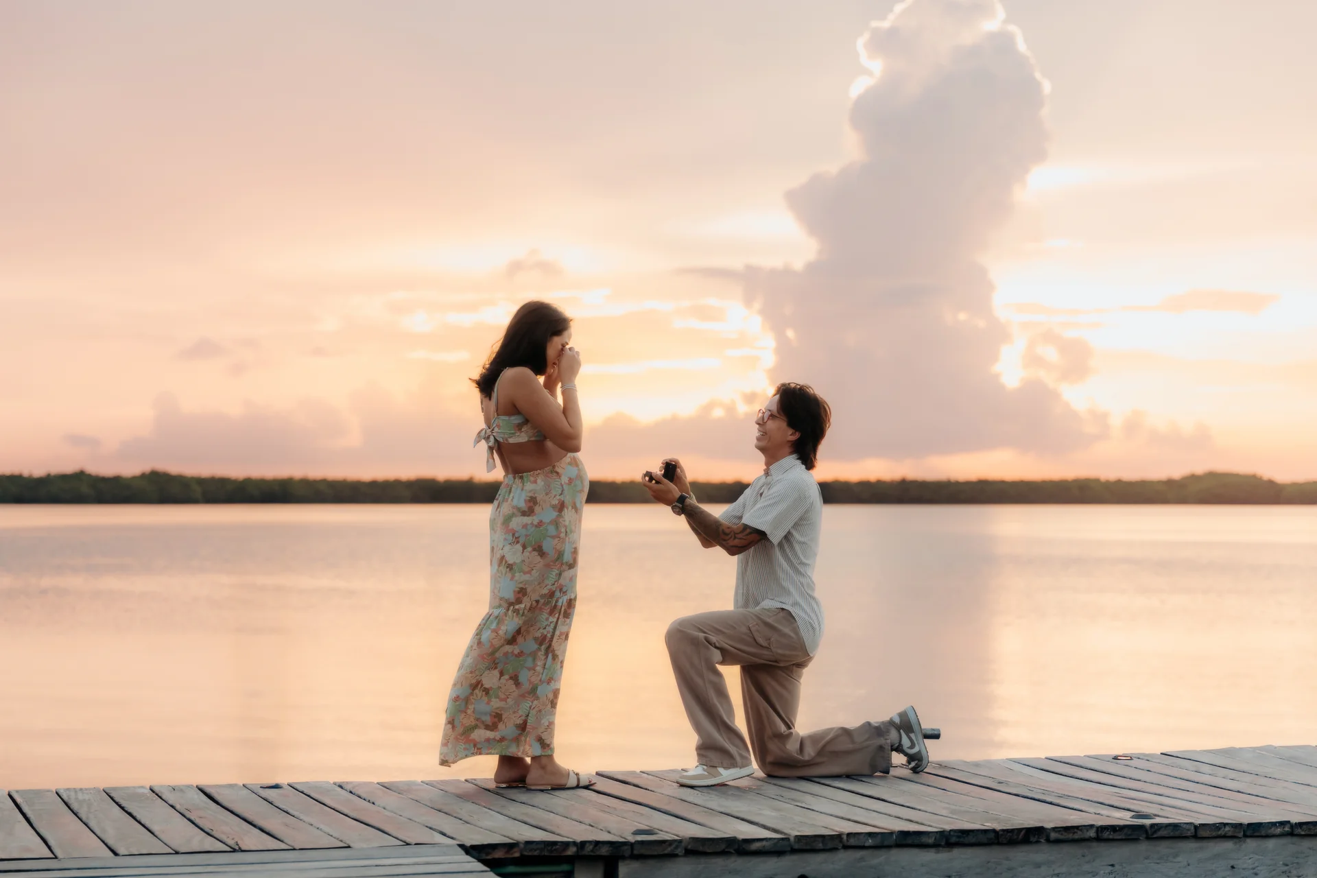 Couple celebrating with the ocean behind them, Navios restaurant, Cancún