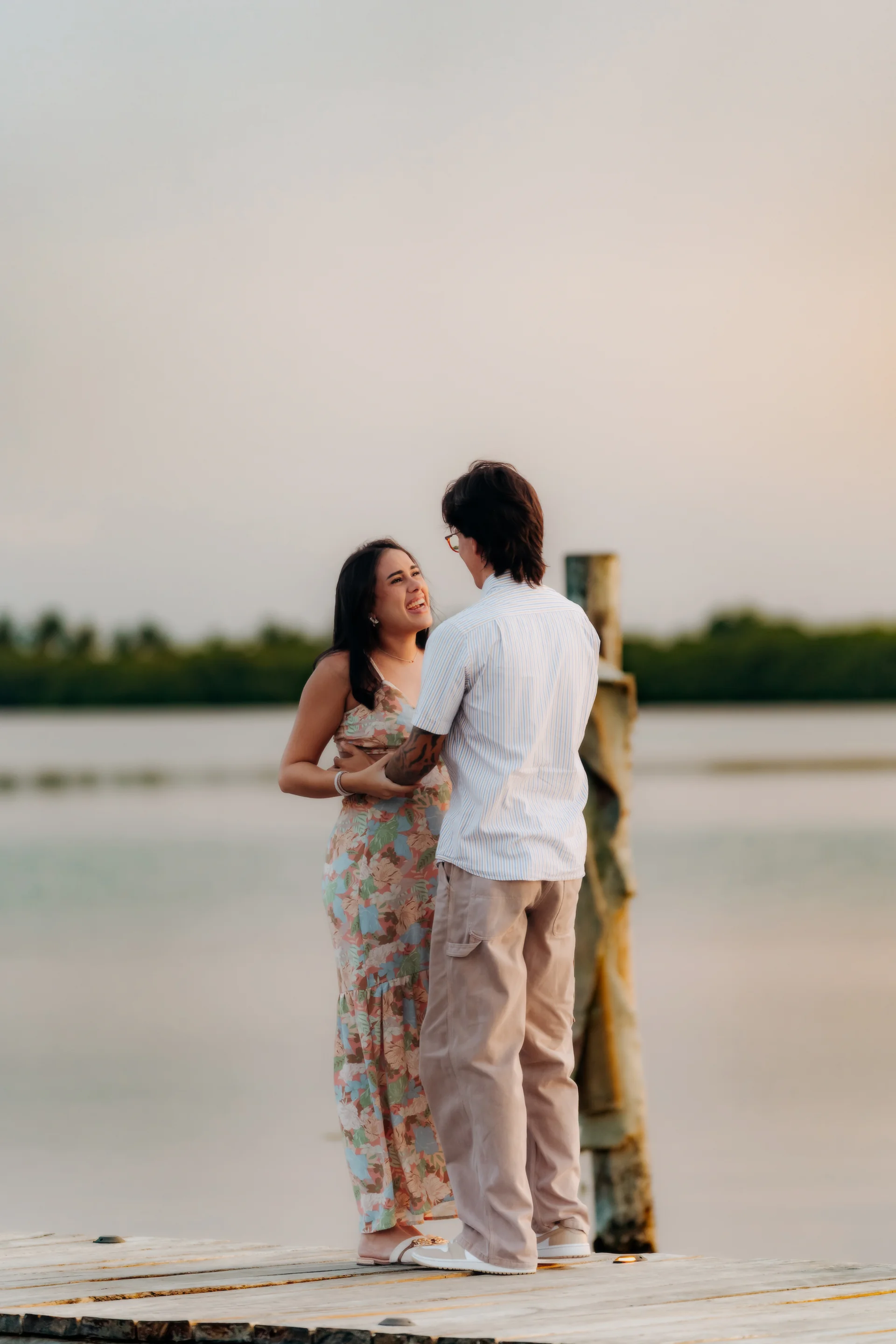 Engaged couple portrait at the shoreline, Navios restaurant, Cancún