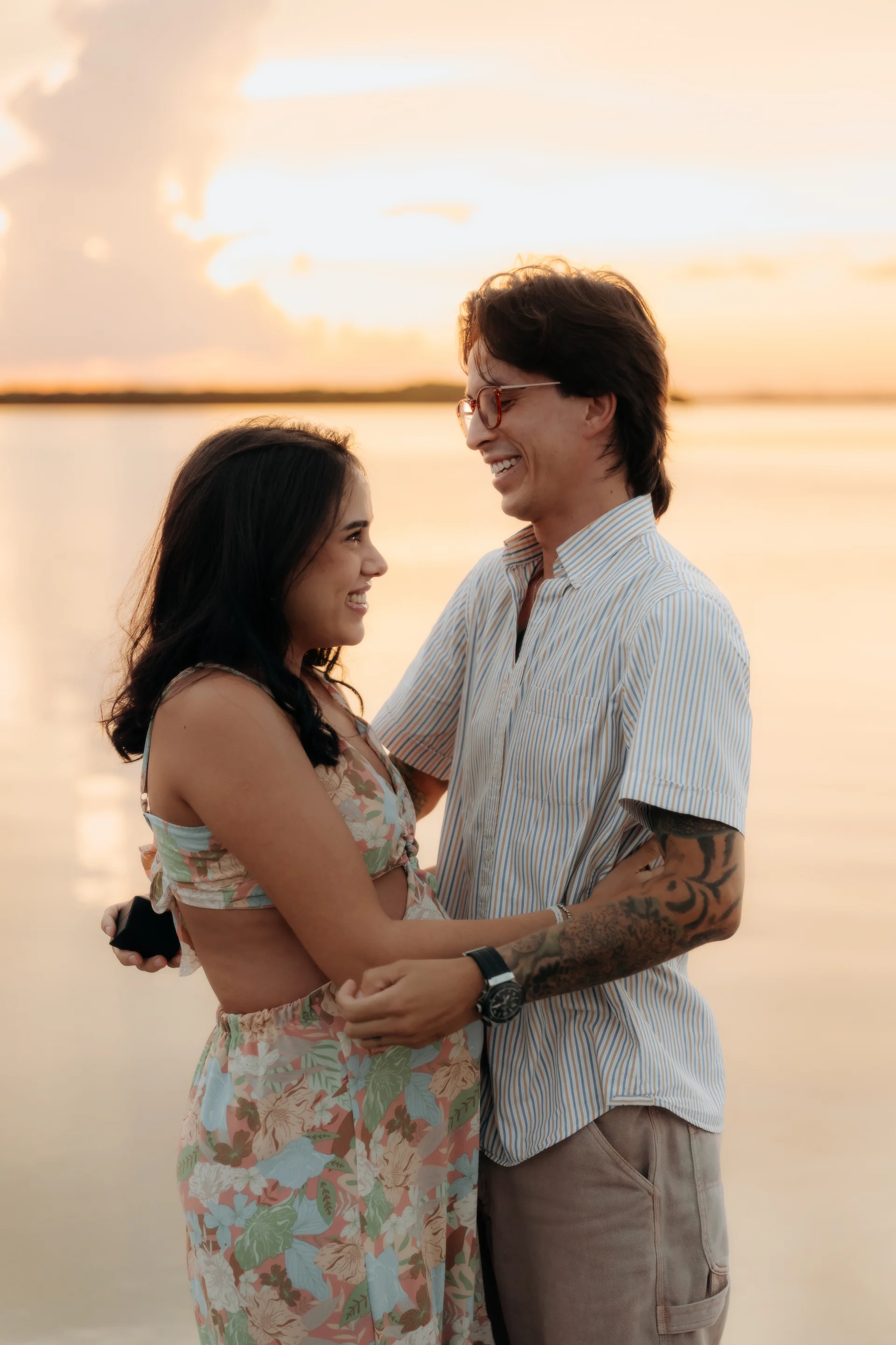 Newly engaged couple laughing on the sand, Navios restaurant, Cancún