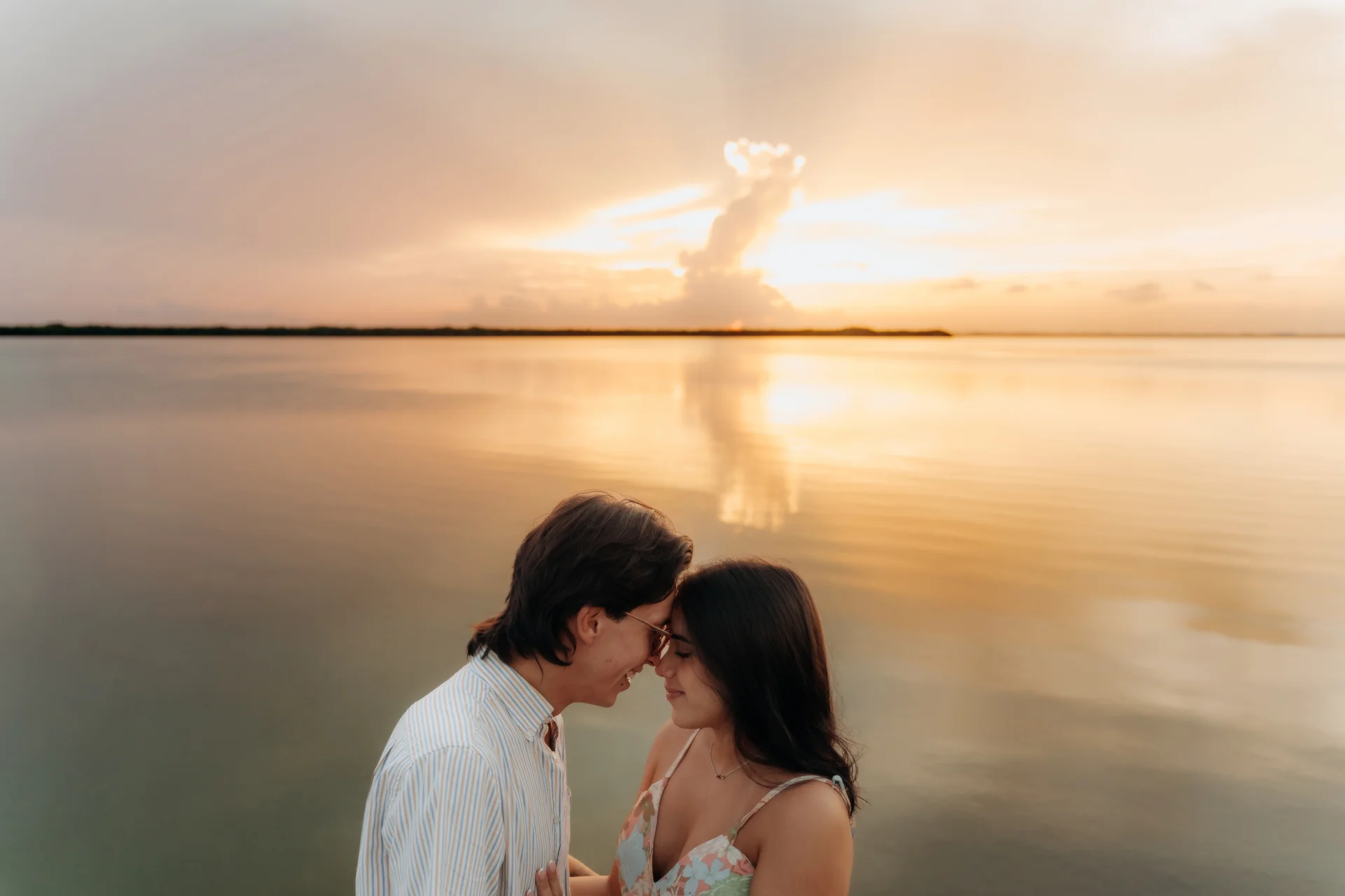 Couple sharing a tender embrace after saying yes, Navios restaurant, Cancún